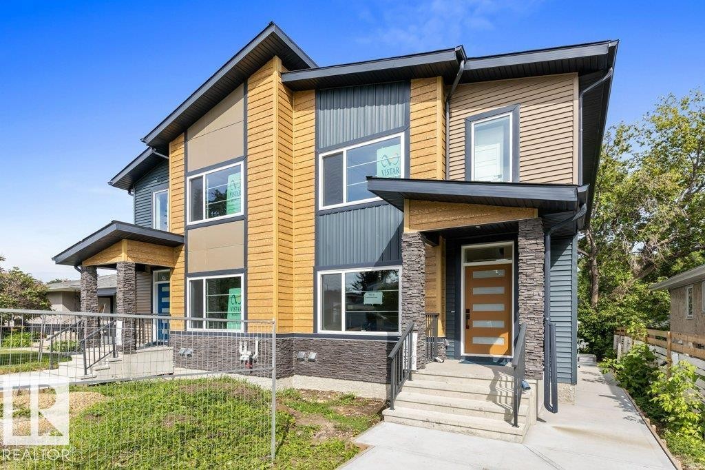 Modern two-story residence featuring a striking mixed-material exterior with warm-toned horizontal siding, stone veneer accents, and contrasting dark trim - 10323 79 Street Nw, Edmonton, AB - Outdoor With Facade