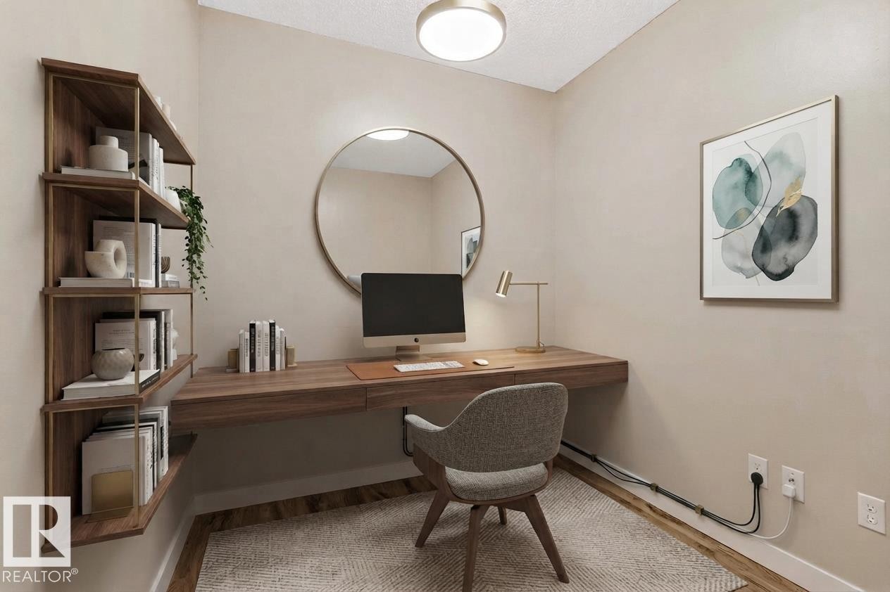 Built-in wood-finish desk with integrated shelving, wood-finish flooring, and recessed ceiling lighting - #120 8931 156 St Nw, Edmonton, AB