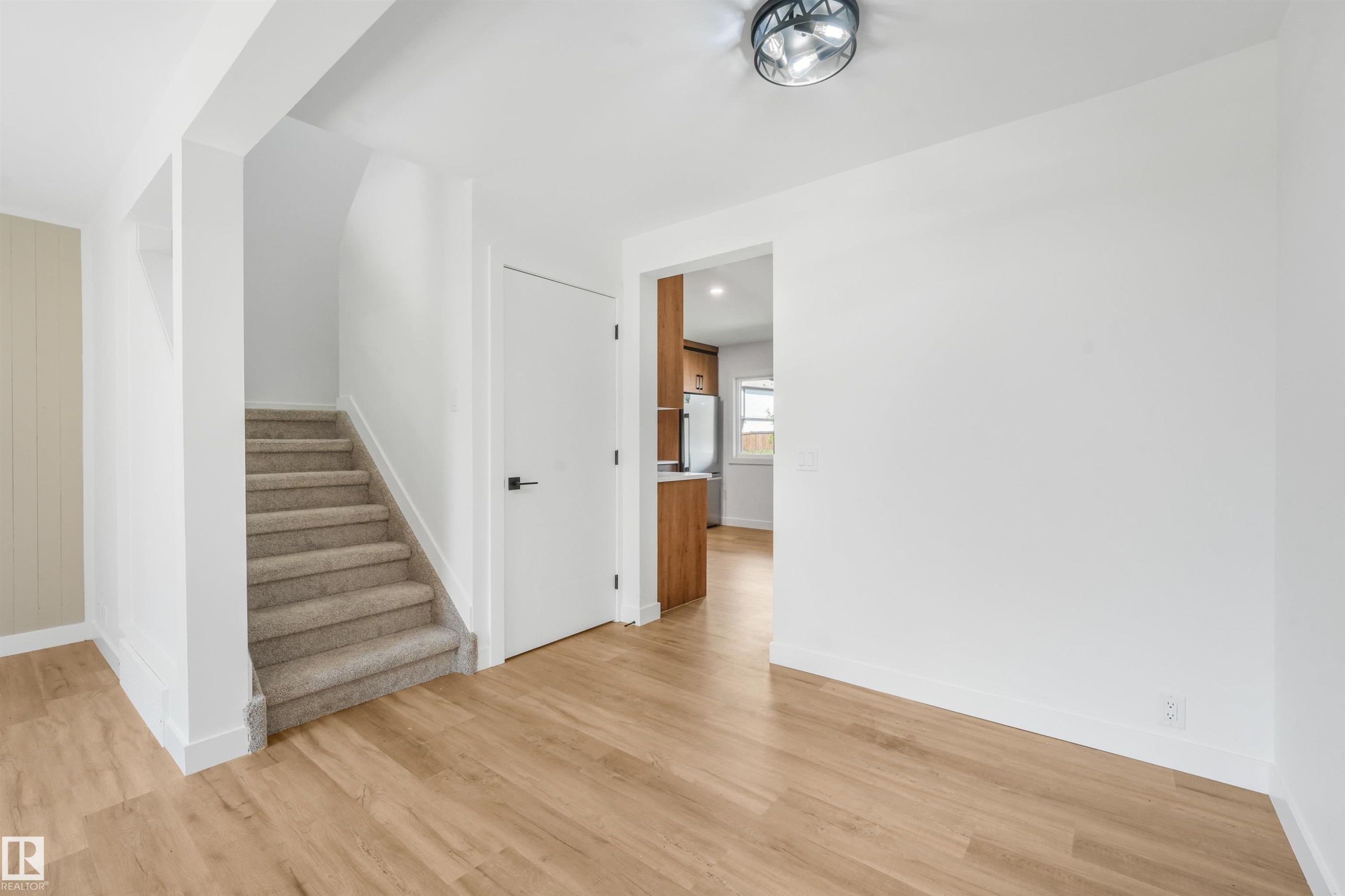 Interior space featuring light wood-finish flooring and white walls - #39 14511 52 Street Nw, Edmonton, AB - Indoor Photo Showing Other Room