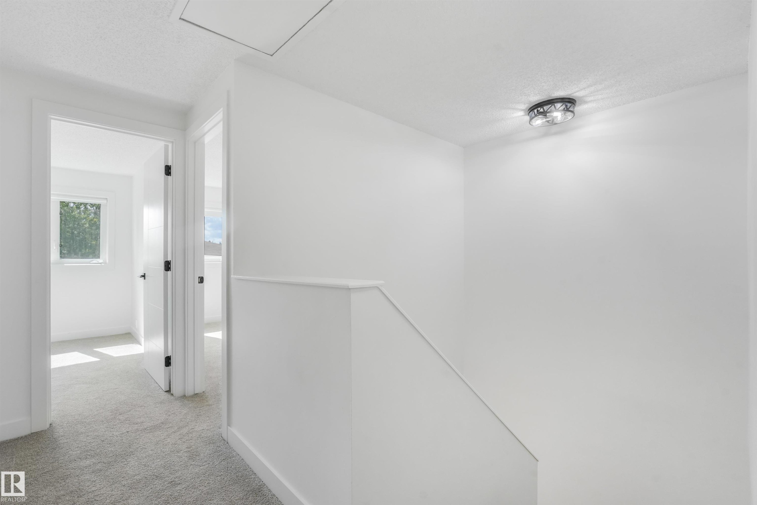 Upper-level hallway featuring light gray carpeting and white painted walls - #39 14511 52 Street Nw, Edmonton, AB - Indoor Photo Showing Other Room