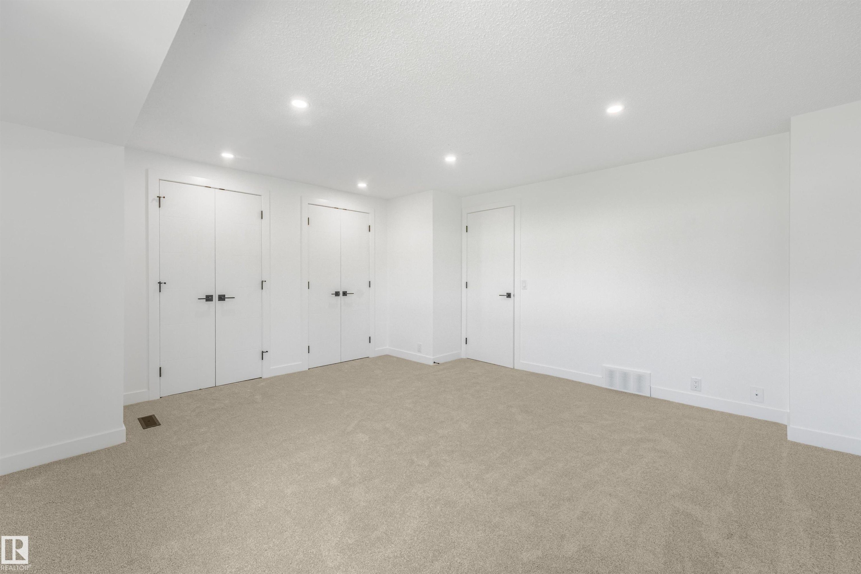 Carpeted room featuring white walls and a white ceiling with recessed lighting - #39 14511 52 Street Nw, Edmonton, AB - Indoor Photo Showing Other Room
