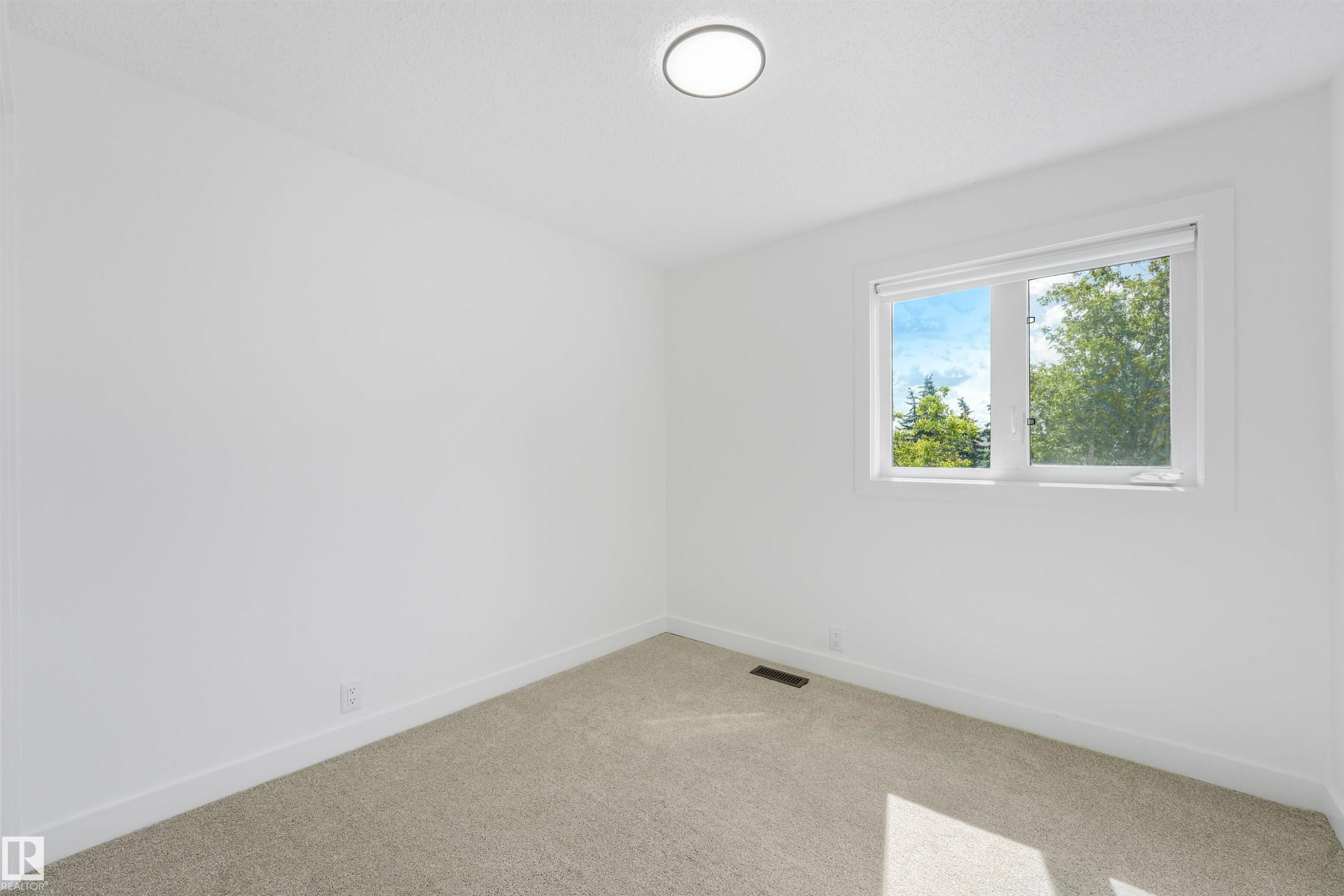 Room featuring a light-colored carpet, white walls, and a window with white trim - #39 14511 52 Street Nw, Edmonton, AB - Indoor Photo Showing Other Room