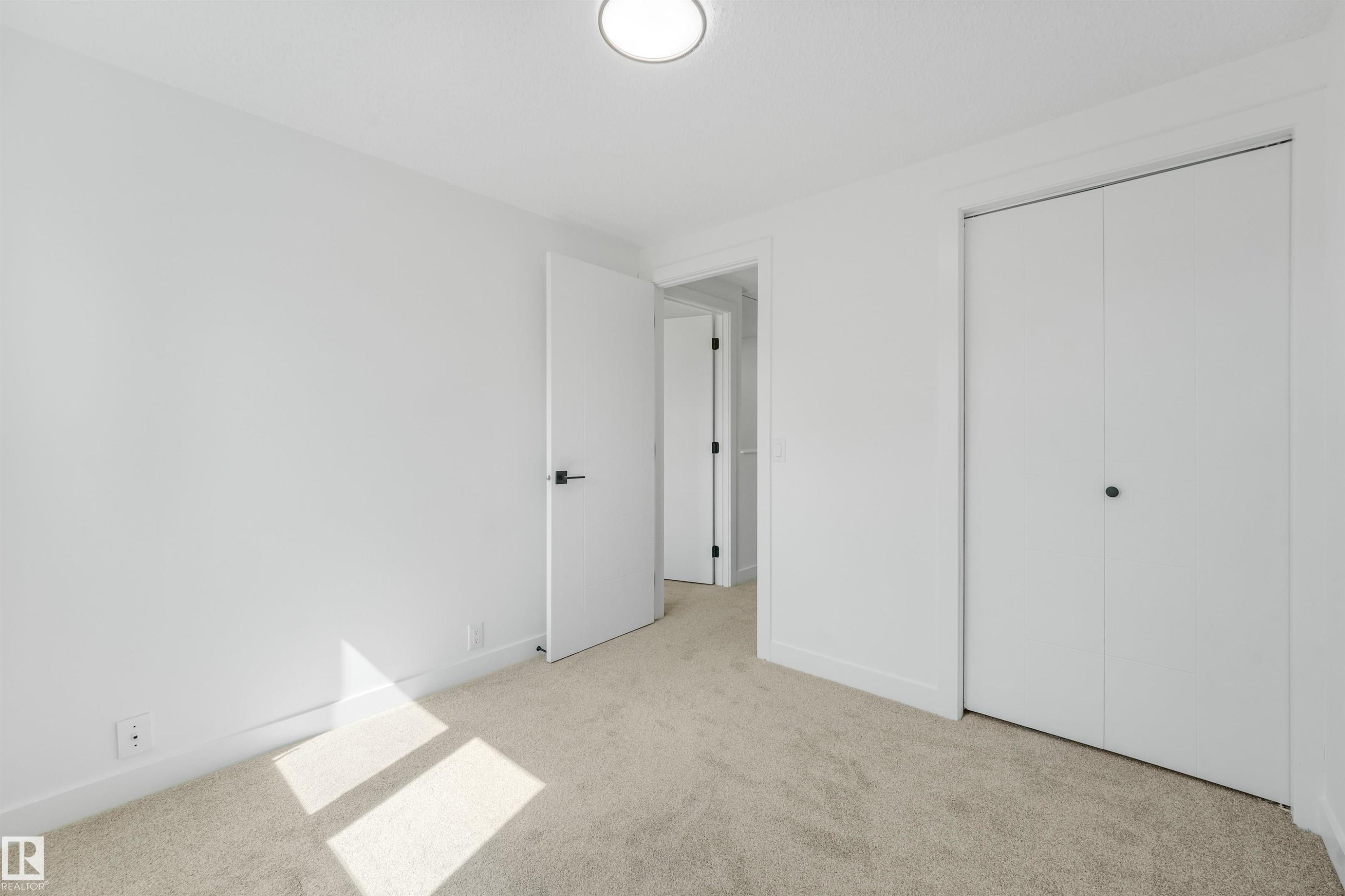 Clean interior space featuring light-toned carpeting and a neutral color palette - #39 14511 52 Street Nw, Edmonton, AB - Indoor Photo Showing Other Room