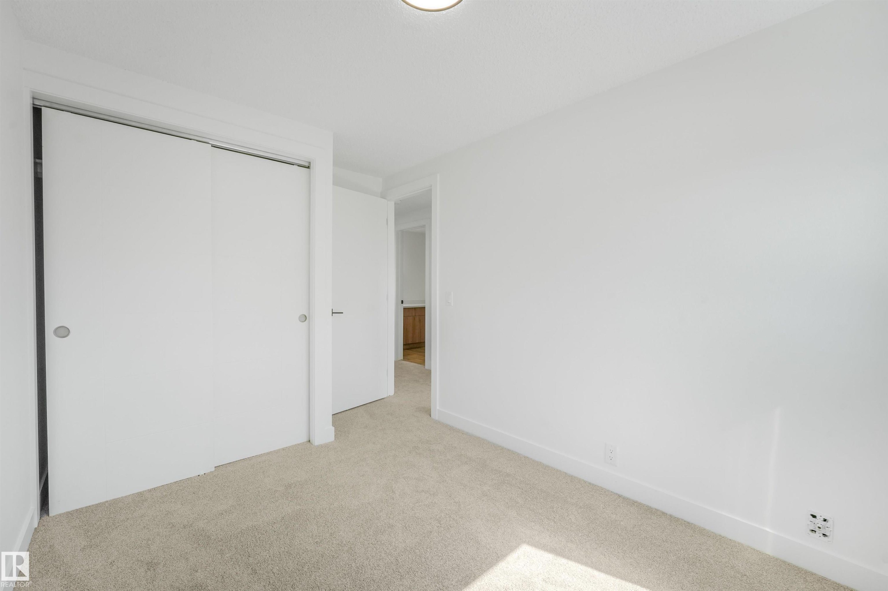 Carpeted interior space featuring white walls and a white ceiling with a flush-mount light fixture - #39 14511 52 Street Nw, Edmonton, AB - Indoor Photo Showing Other Room