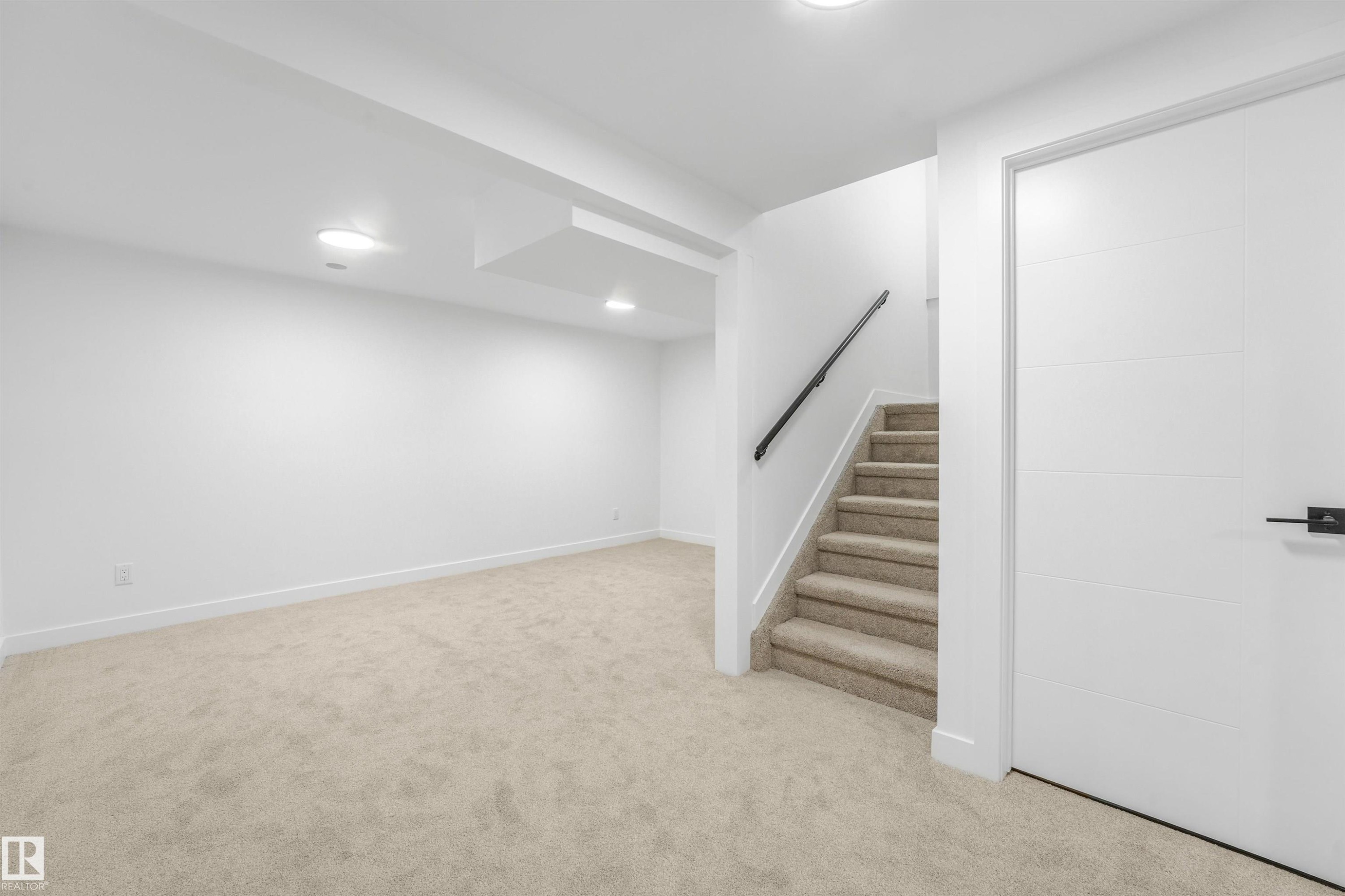 Carpeted staircase with black handrail - #39 14511 52 Street Nw, Edmonton, AB - Indoor