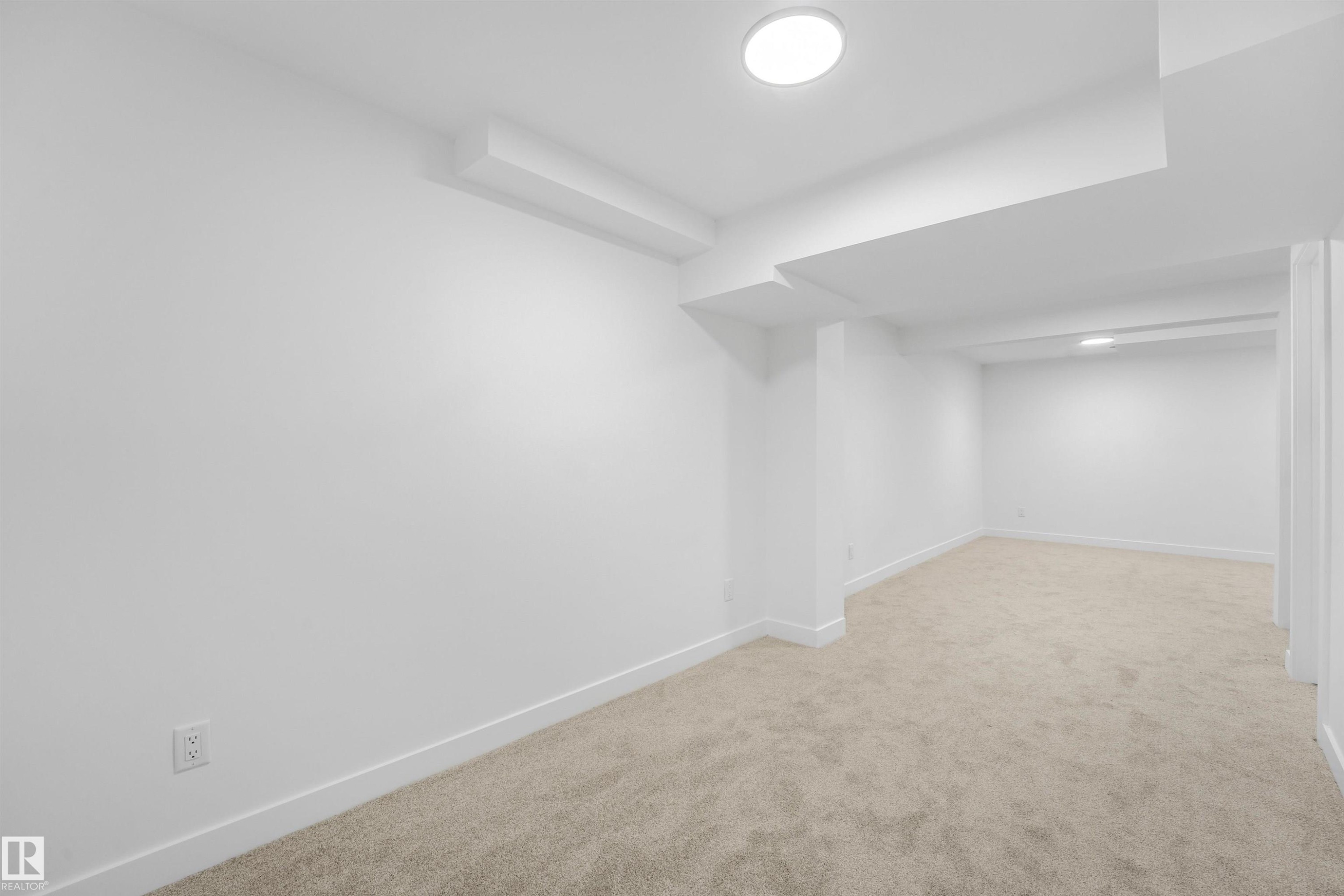 Spacious room featuring neutral carpet flooring, white walls, and recessed lighting fixtures - #39 14511 52 Street Nw, Edmonton, AB - Indoor