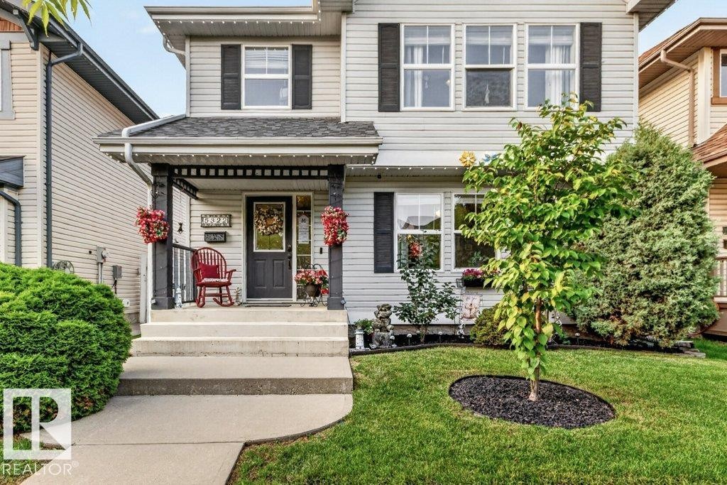Contemporary two-story exterior with light-toned siding and dark shutters - 5322 Terwillegar Boulevard Nw, Edmonton, AB - Outdoor With Deck Patio Veranda