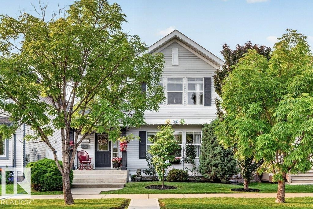 Gabled two-story home featuring light grey siding and dark shutters - 5322 Terwillegar Boulevard Nw, Edmonton, AB - Outdoor