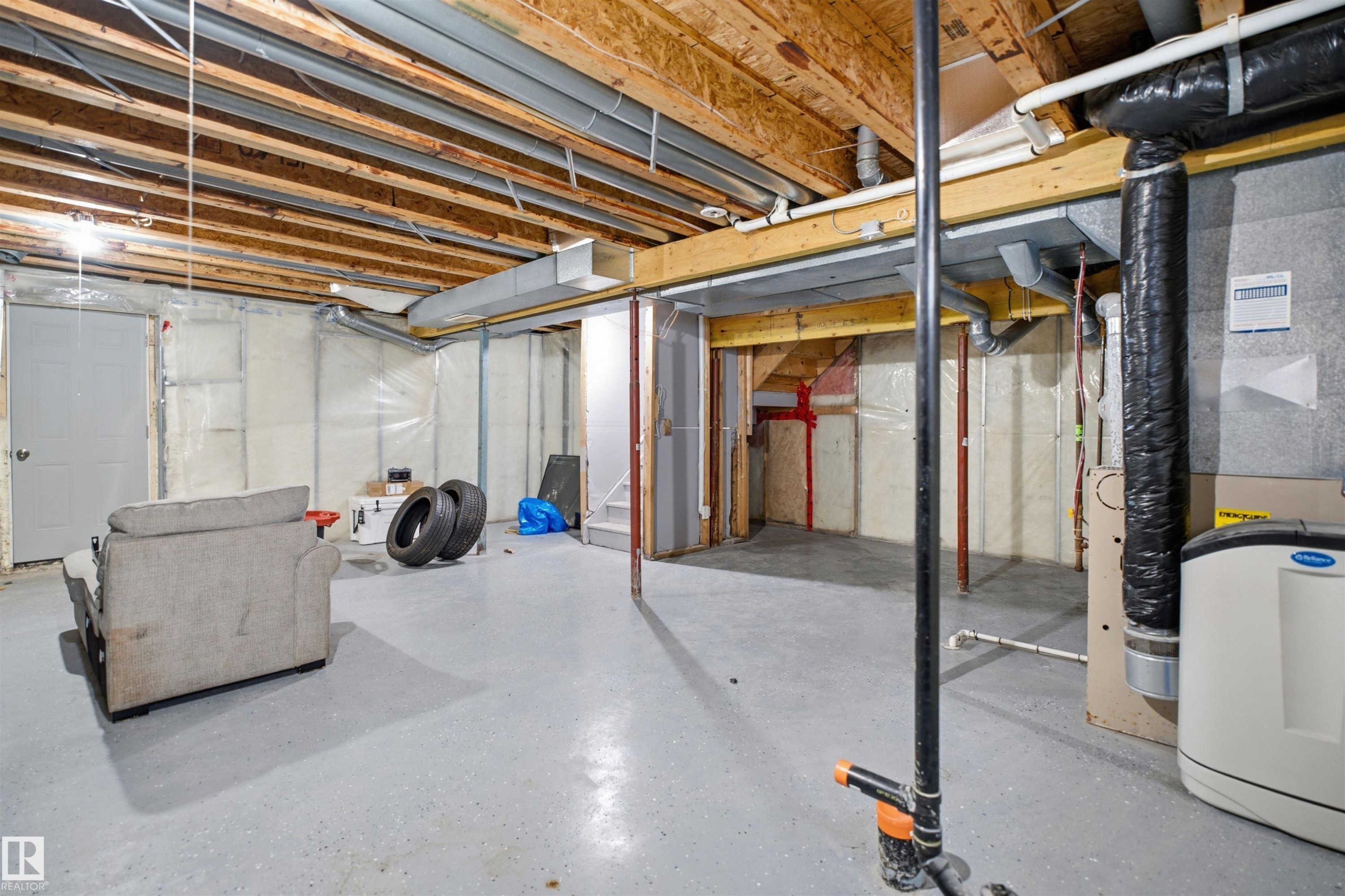 Unfinished basement with exposed ceiling joists and concrete flooring - 714 87 Street Sw, Edmonton, AB - Indoor Photo Showing Basement