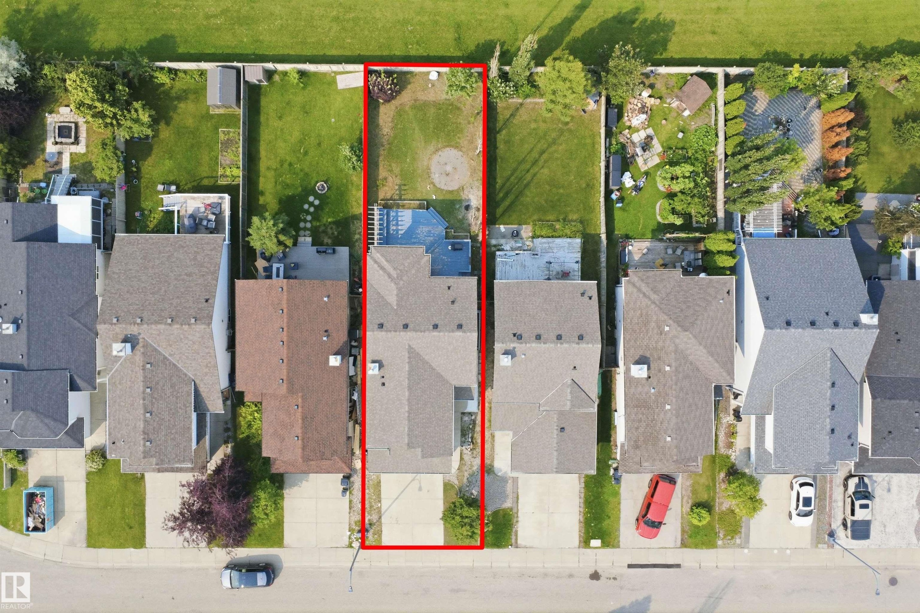 Aerial perspective highlighting a residential property with a paved driveway and a two-story structure featuring a gabled roof - 714 87 Street Sw, Edmonton, AB -