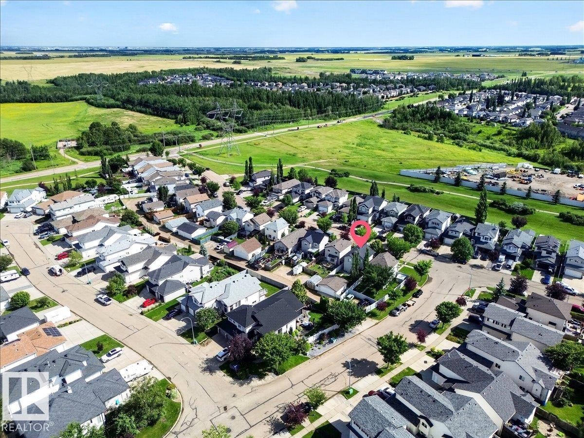 Aerial view of a well-planned residential community featuring organized street layouts, diverse architectural styles, and generous lot sizes - 887 Oakland Boulevard, Devon, AB - Outdoor With View