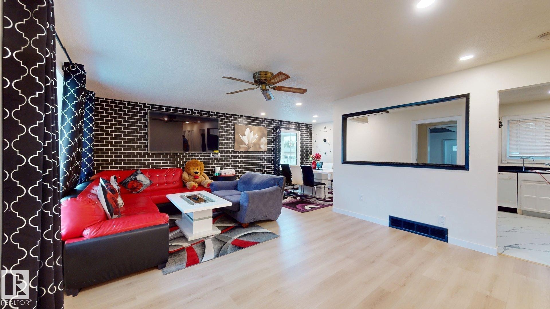 Open-concept living space featuring wood-finish flooring, recessed lighting, and a ceiling fan - 12812 45 Street Nw, Edmonton, AB - Indoor Photo Showing Other Room