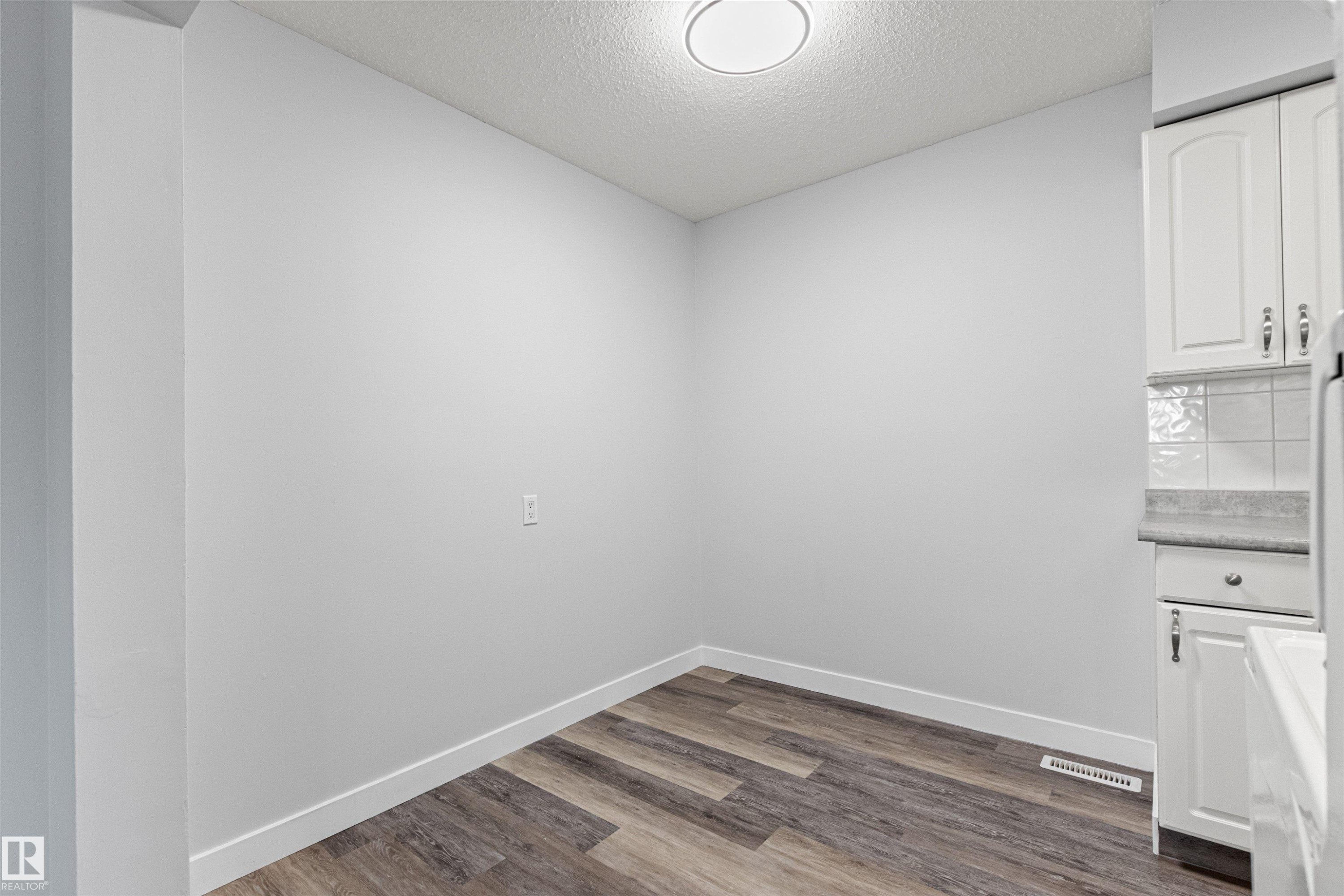 White cabinetry with brushed nickel hardware - #9 14230 80 St Nw, Edmonton, AB - Indoor Photo Showing Other Room