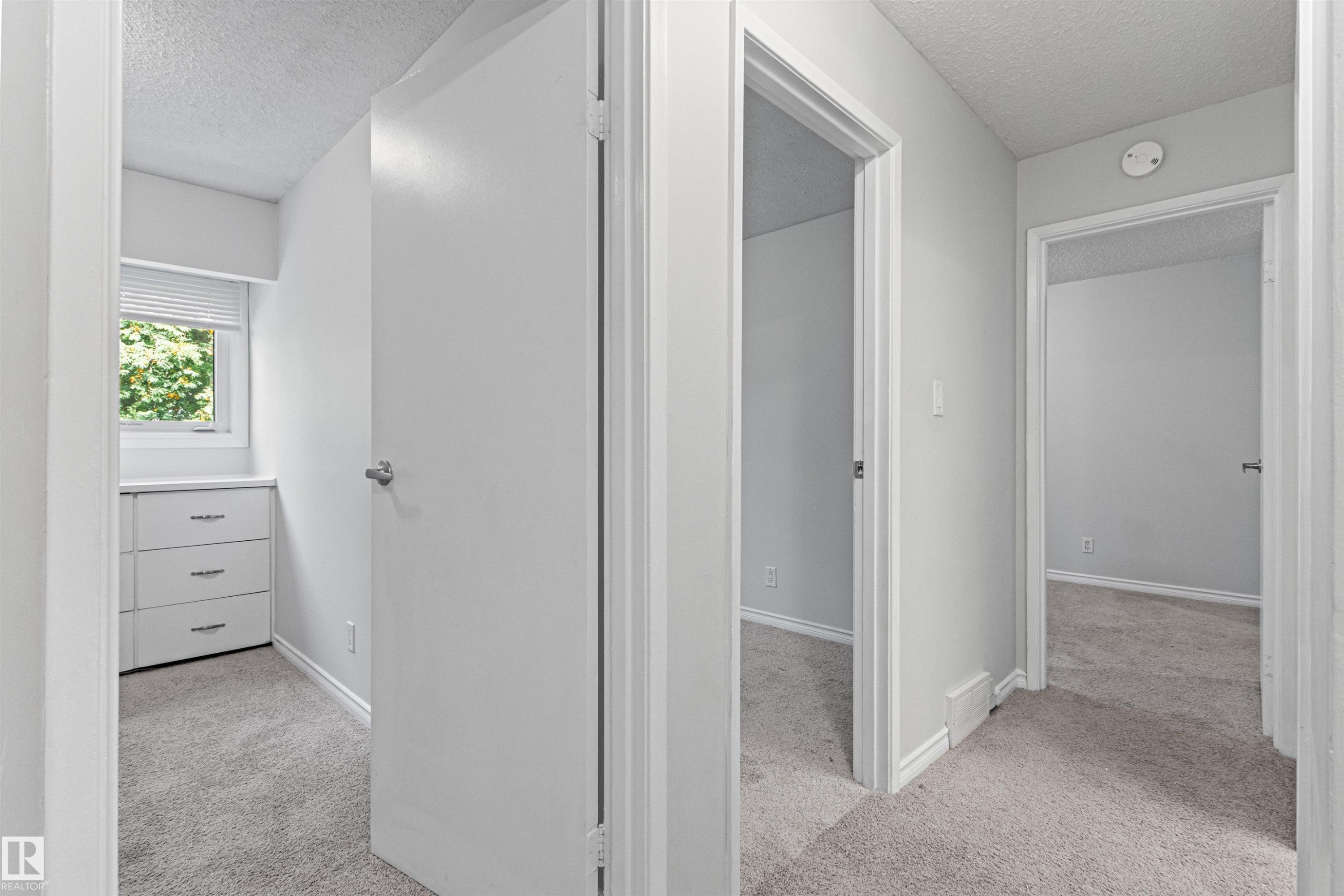 Light gray carpet throughout - #9 14230 80 St Nw, Edmonton, AB - Indoor Photo Showing Other Room
