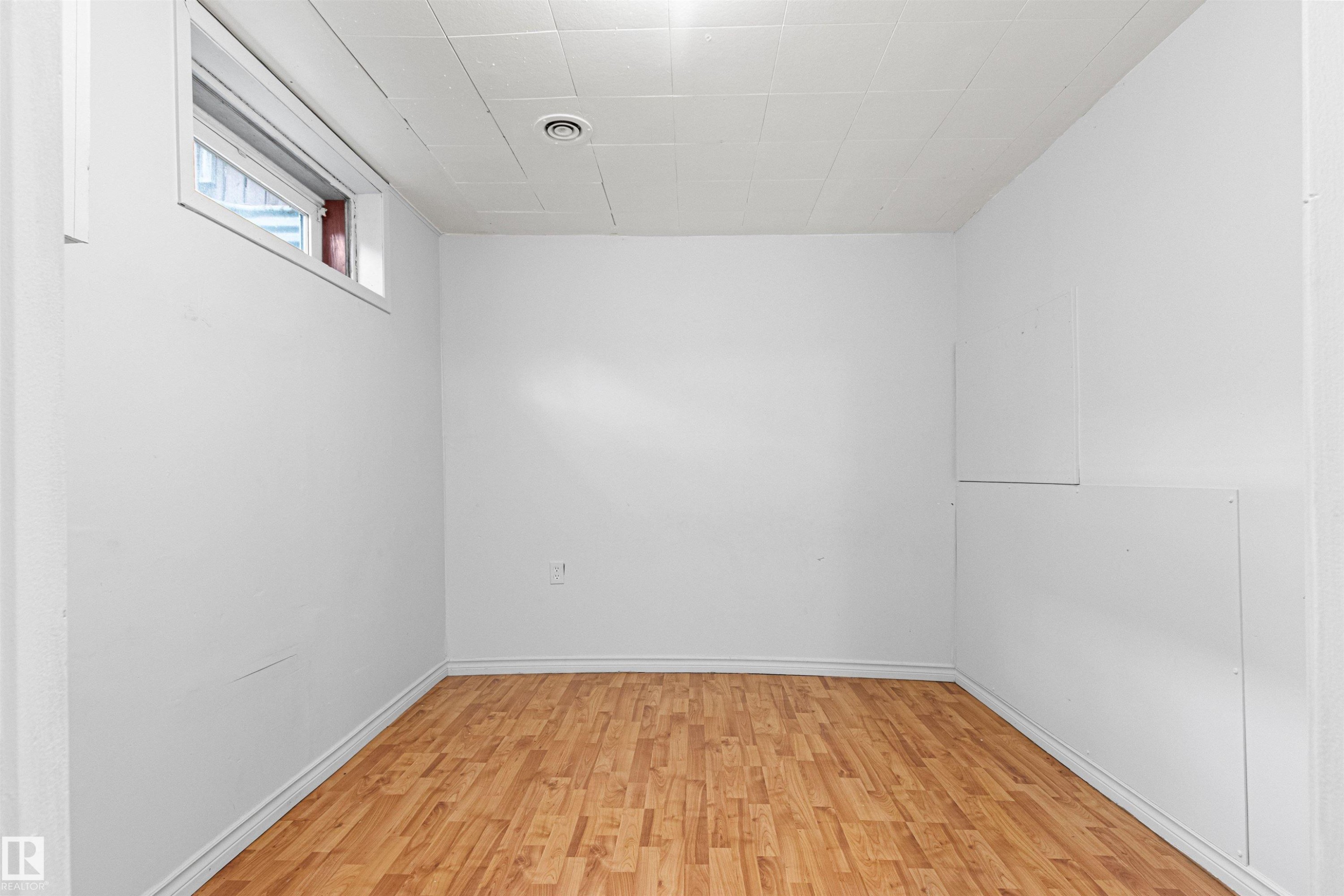 Wood-finish flooring with white walls - #9 14230 80 St Nw, Edmonton, AB - Indoor Photo Showing Other Room