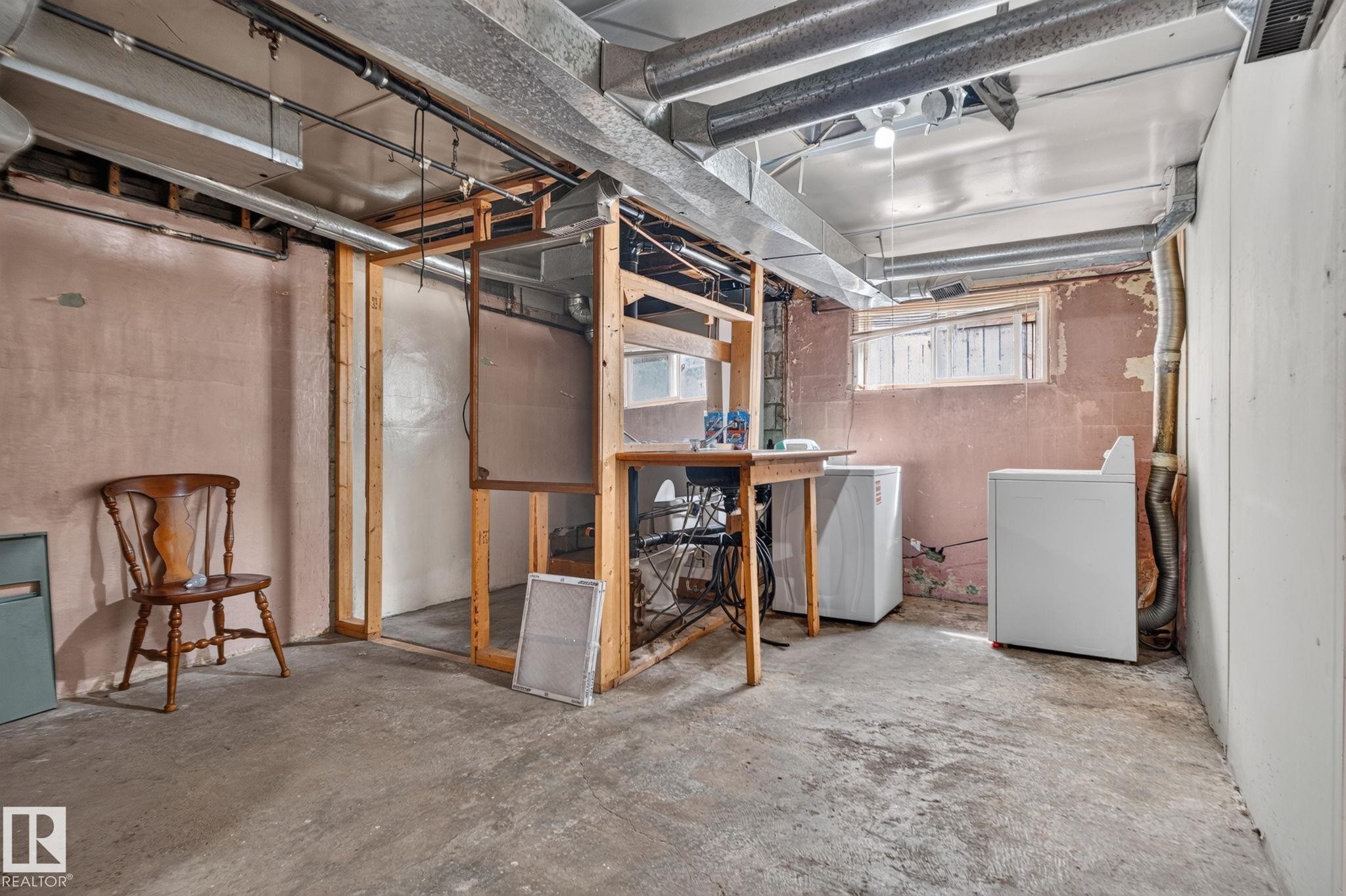 Lower-level utility area with exposed ductwork, concrete flooring, and partial framing - 9921 109 Street, Fort Saskatchewan, AB - Indoor Photo Showing Basement