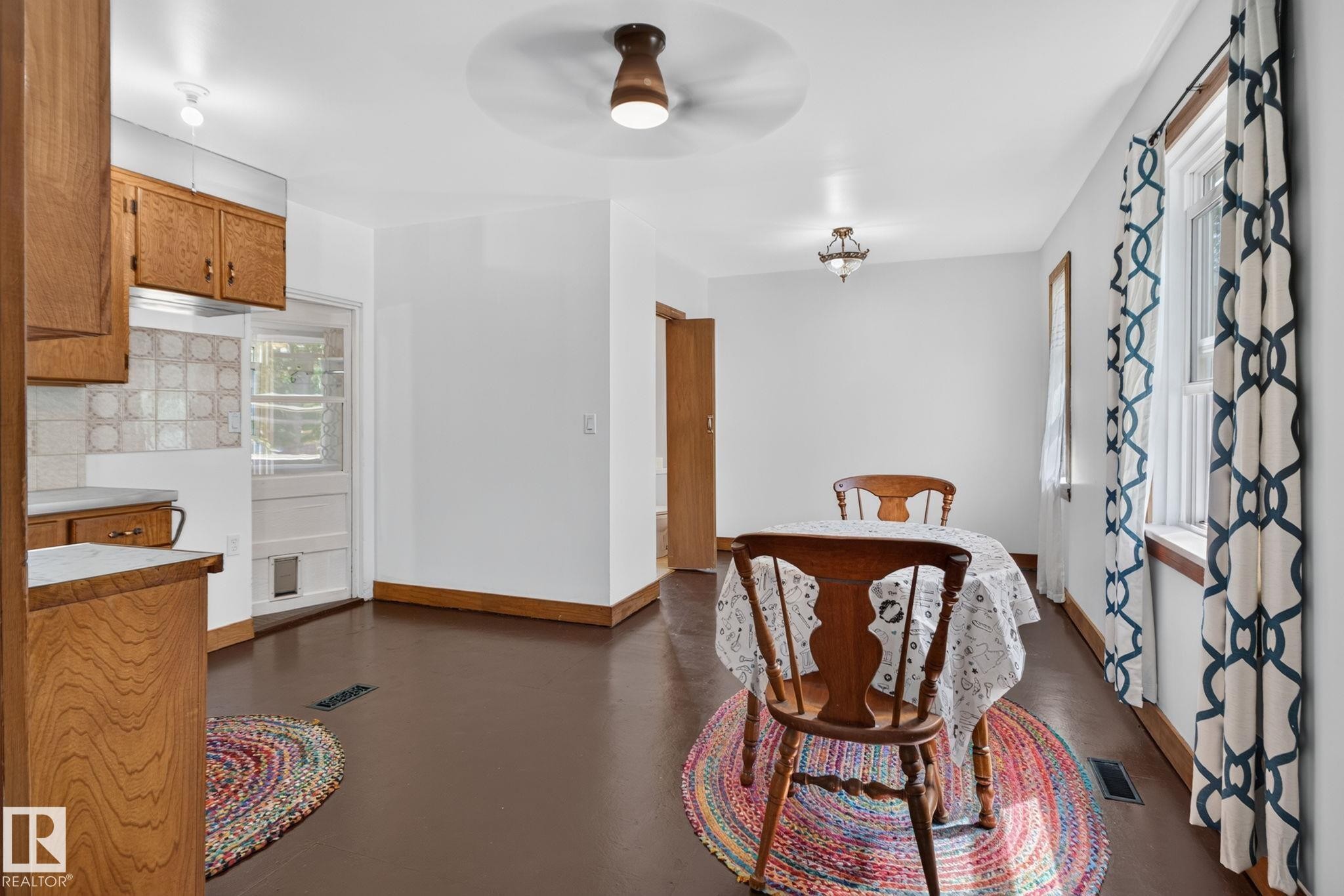 Wood-finish flooring with white walls and natural wood trim throughout - 9921 109 Street, Fort Saskatchewan, AB - Indoor