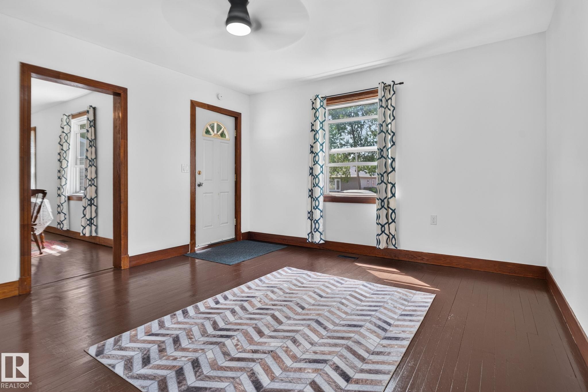 Dark wood-finish flooring with crisp white walls - 9921 109 Street, Fort Saskatchewan, AB - Indoor