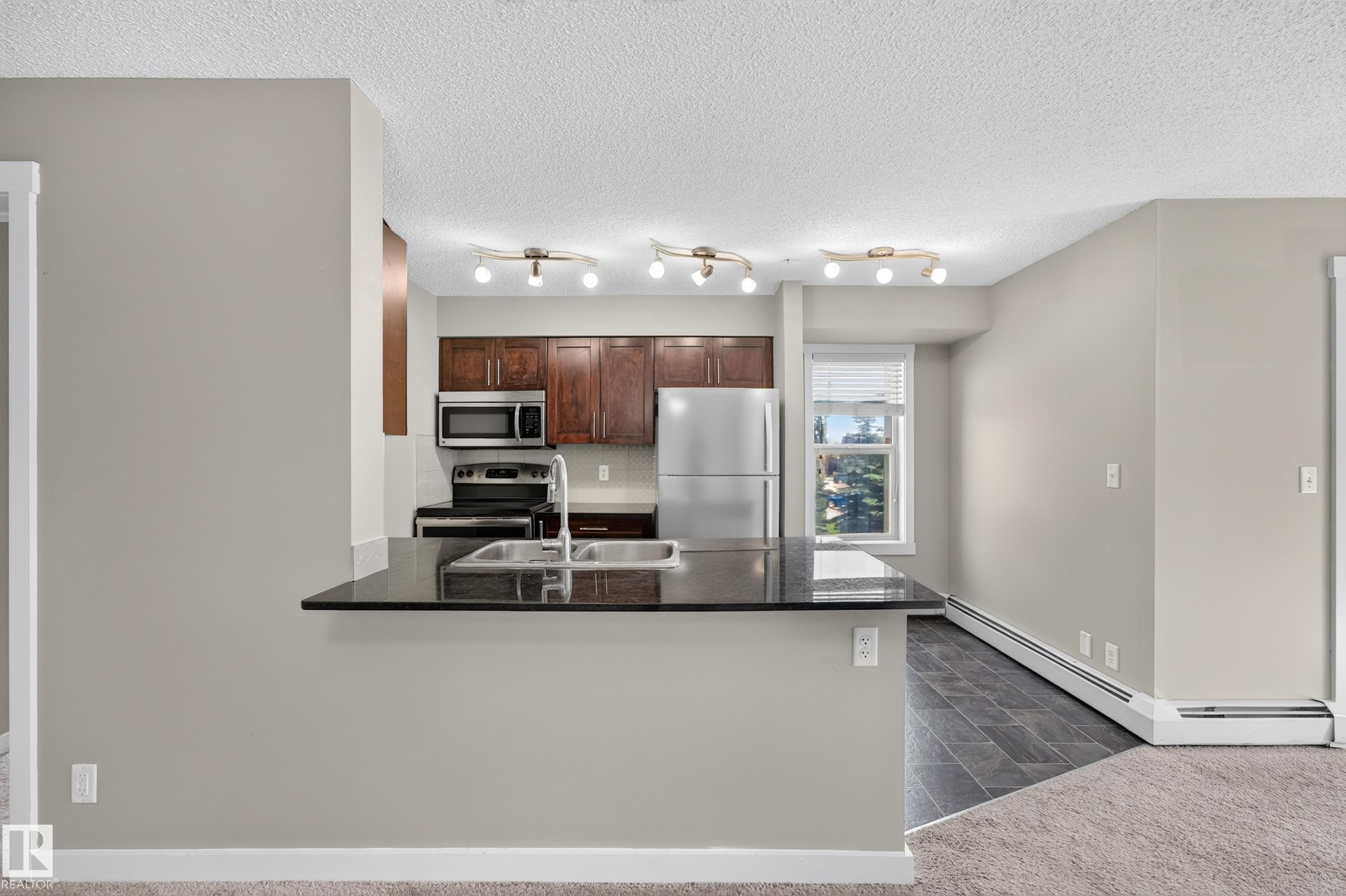 #222 5810 Mullen Pl Nw, Edmonton, AB - Indoor Photo Showing Kitchen With Double Sink
