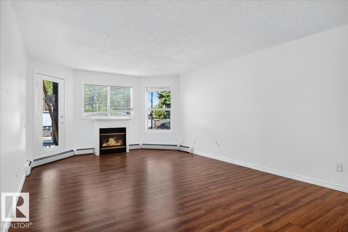 #122 2903 Rabbit Hill Rd Nw, Edmonton, AB - Indoor Photo Showing Living Room With Fireplace