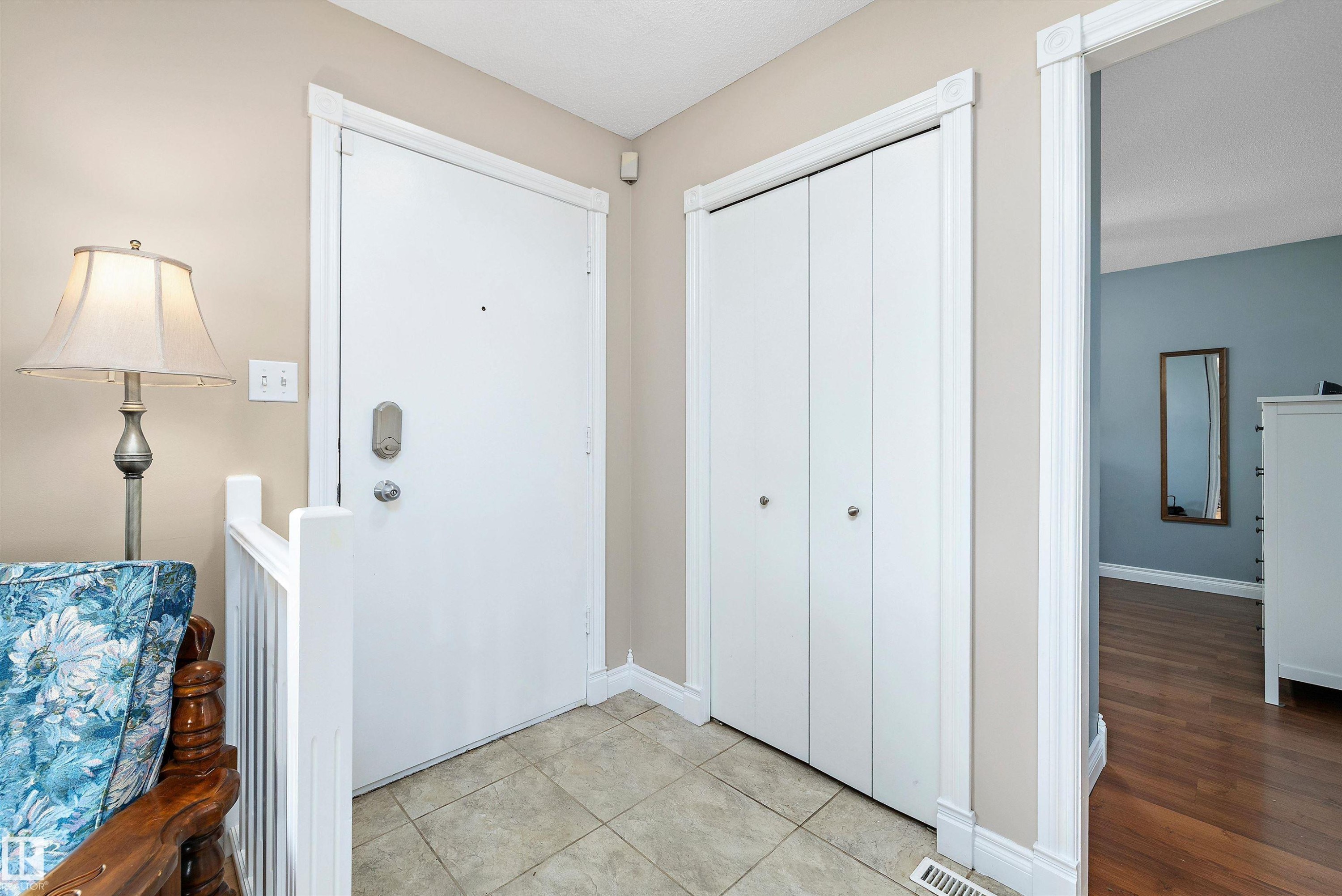 Welcoming entryway showcasing ceramic tile flooring, white panel doors with brushed nickel hardware, neutral wall finishes, and recessed ceiling lighting - 3511 73 Street Nw, Edmonton, AB - Indoor Photo Showing Other Room