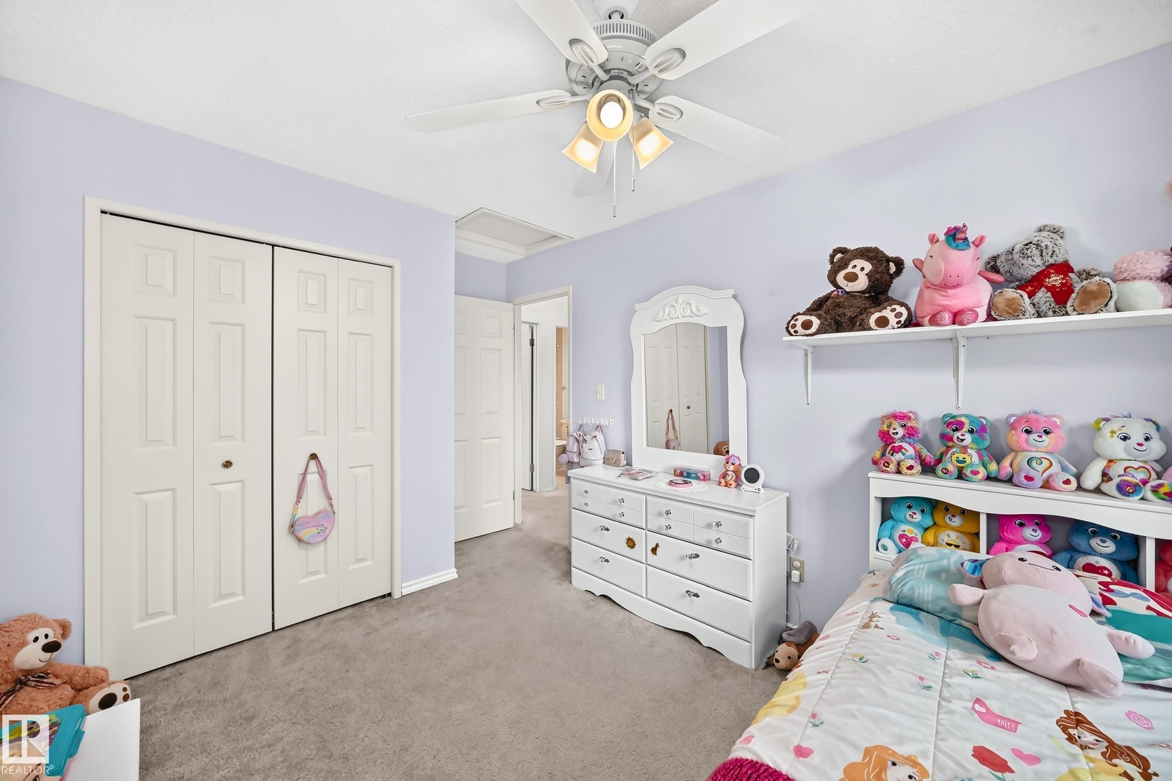 Recessed paneled bi-fold closet doors, wall-to-wall carpeting, and a ceiling fan with integrated lighting - 2404 37 Street Nw, Edmonton, AB - Indoor Photo Showing Bedroom