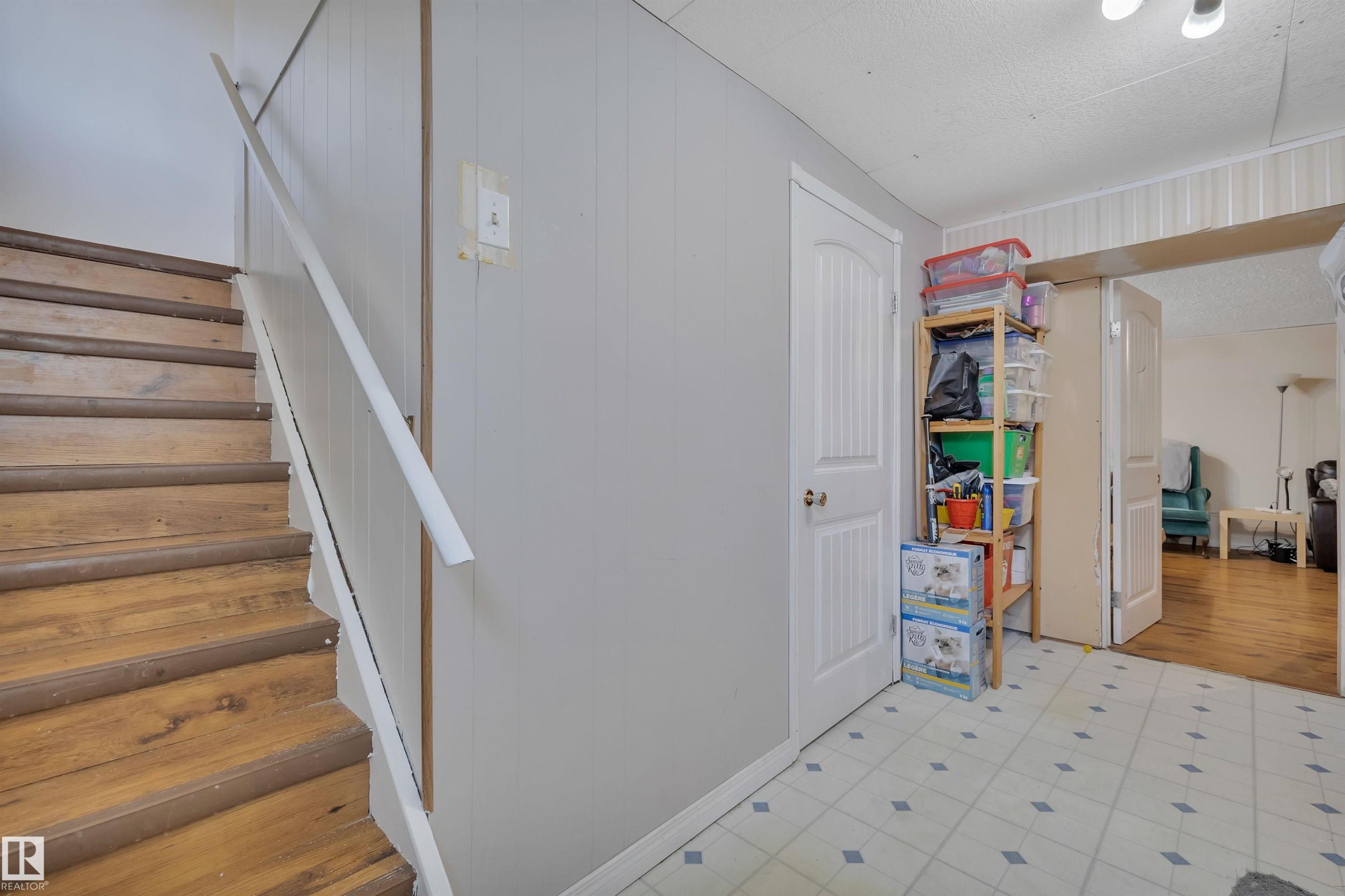 Wood-finish staircase with white handrail - 5411 44 Ave, Wetaskiwin, AB - Indoor Photo Showing Other Room