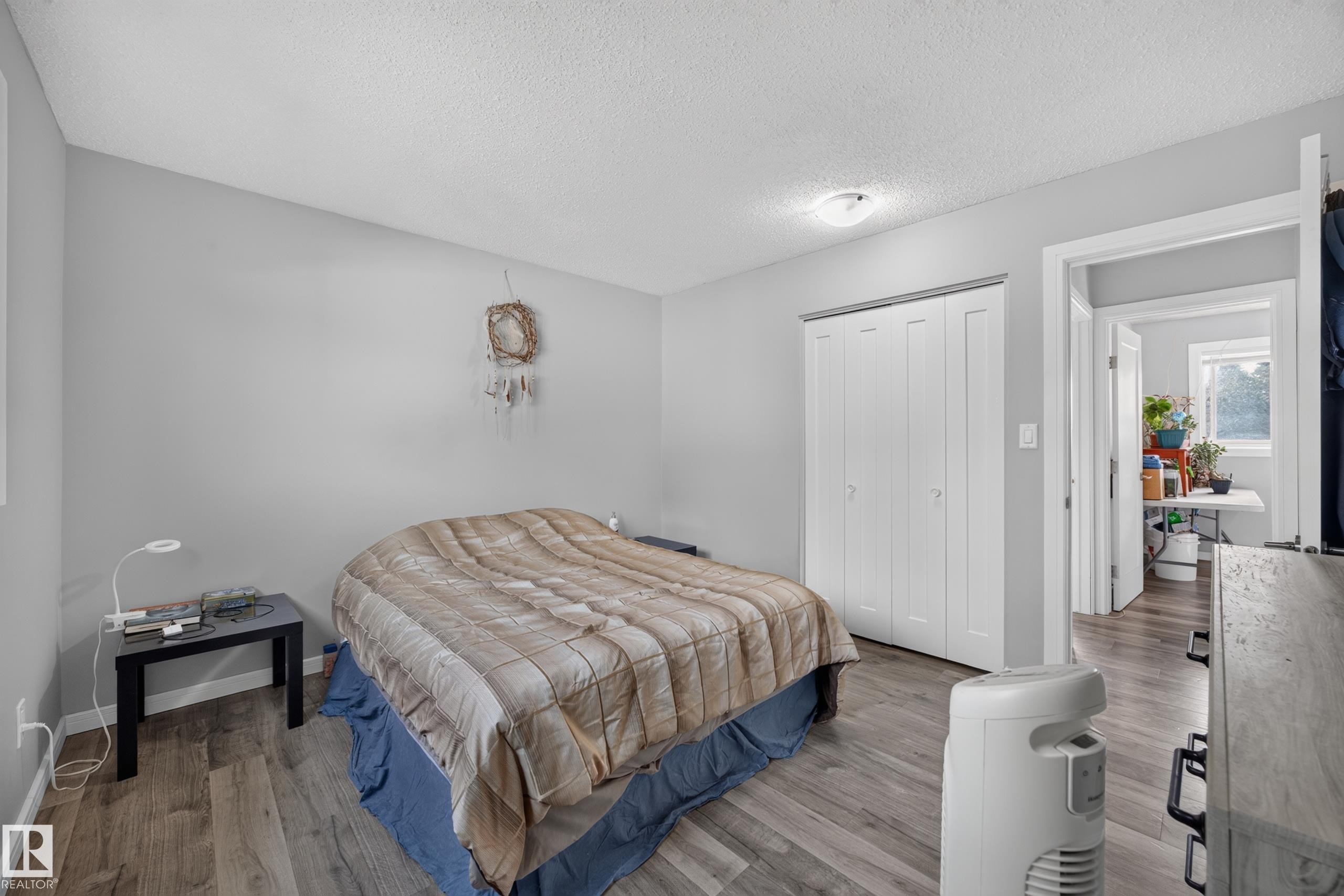 Wood-finish flooring with a neutral color palette - 156 Clareview Road Nw, Edmonton, AB - Indoor Photo Showing Bedroom