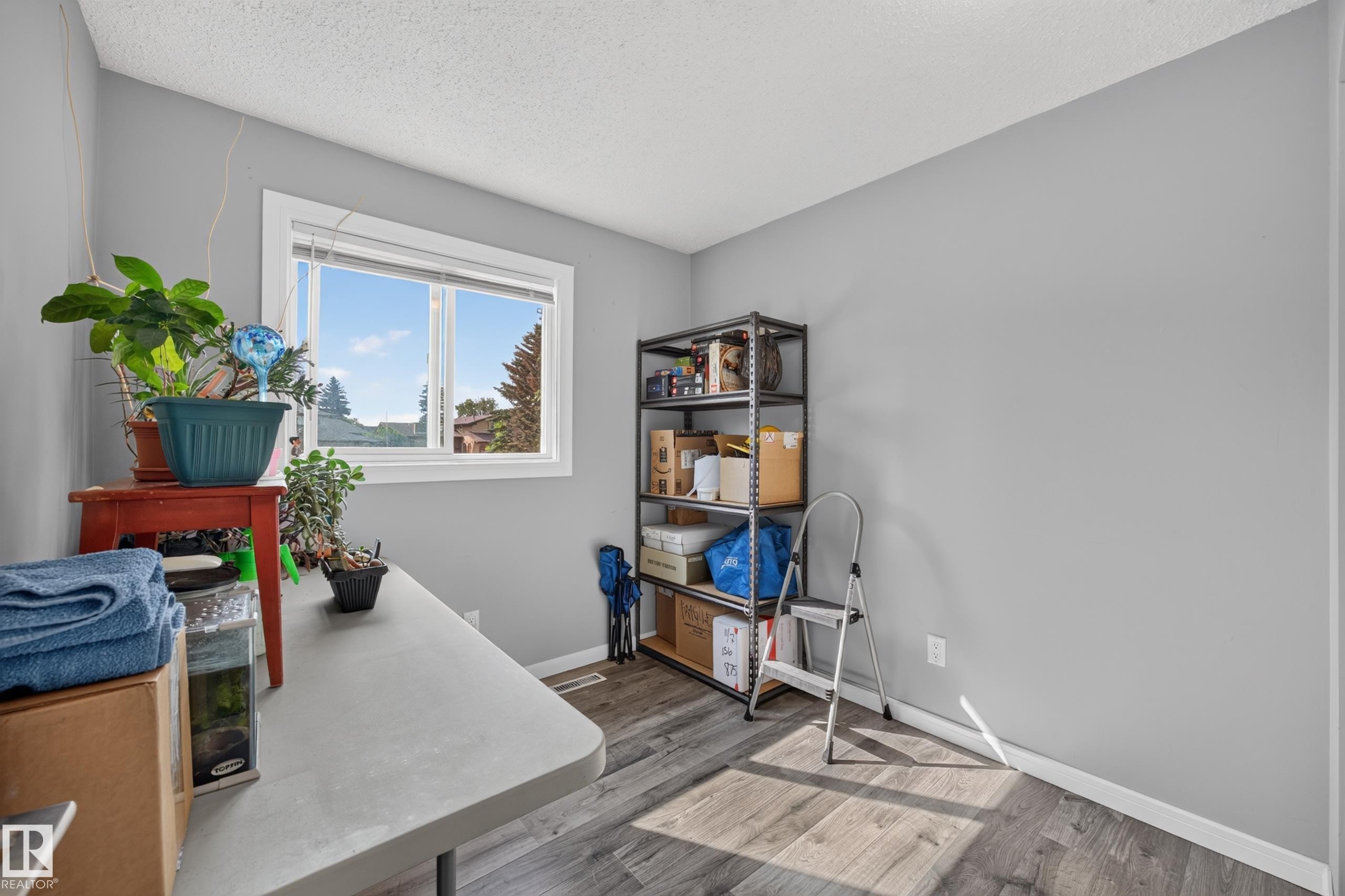 Window with white trim, wood-finish flooring, and light gray wall paint - 156 Clareview Road Nw, Edmonton, AB - Indoor