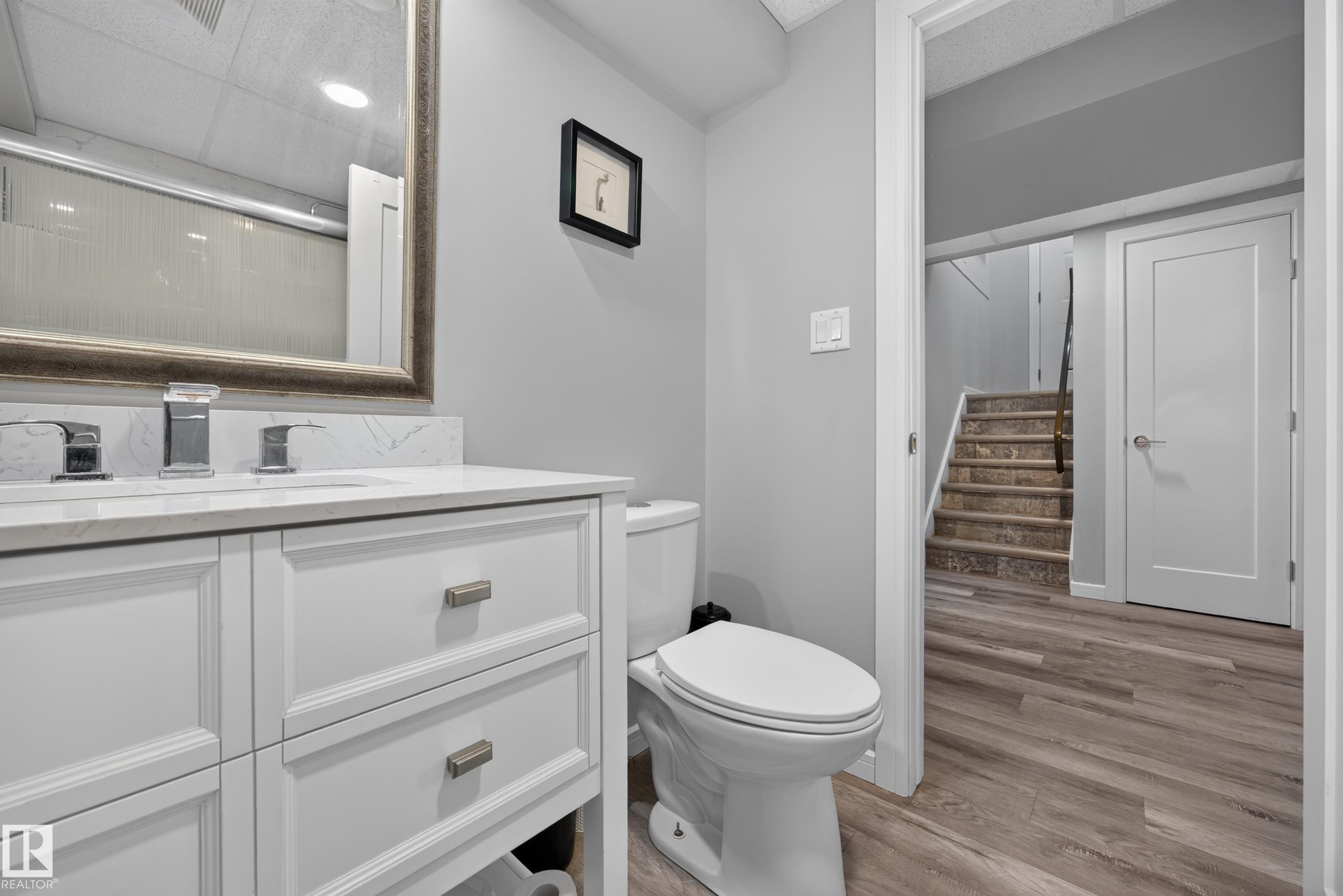 White vanity with paneled doors and drawers, chrome faucets, and a white countertop - 156 Clareview Road Nw, Edmonton, AB - Indoor Photo Showing Bathroom