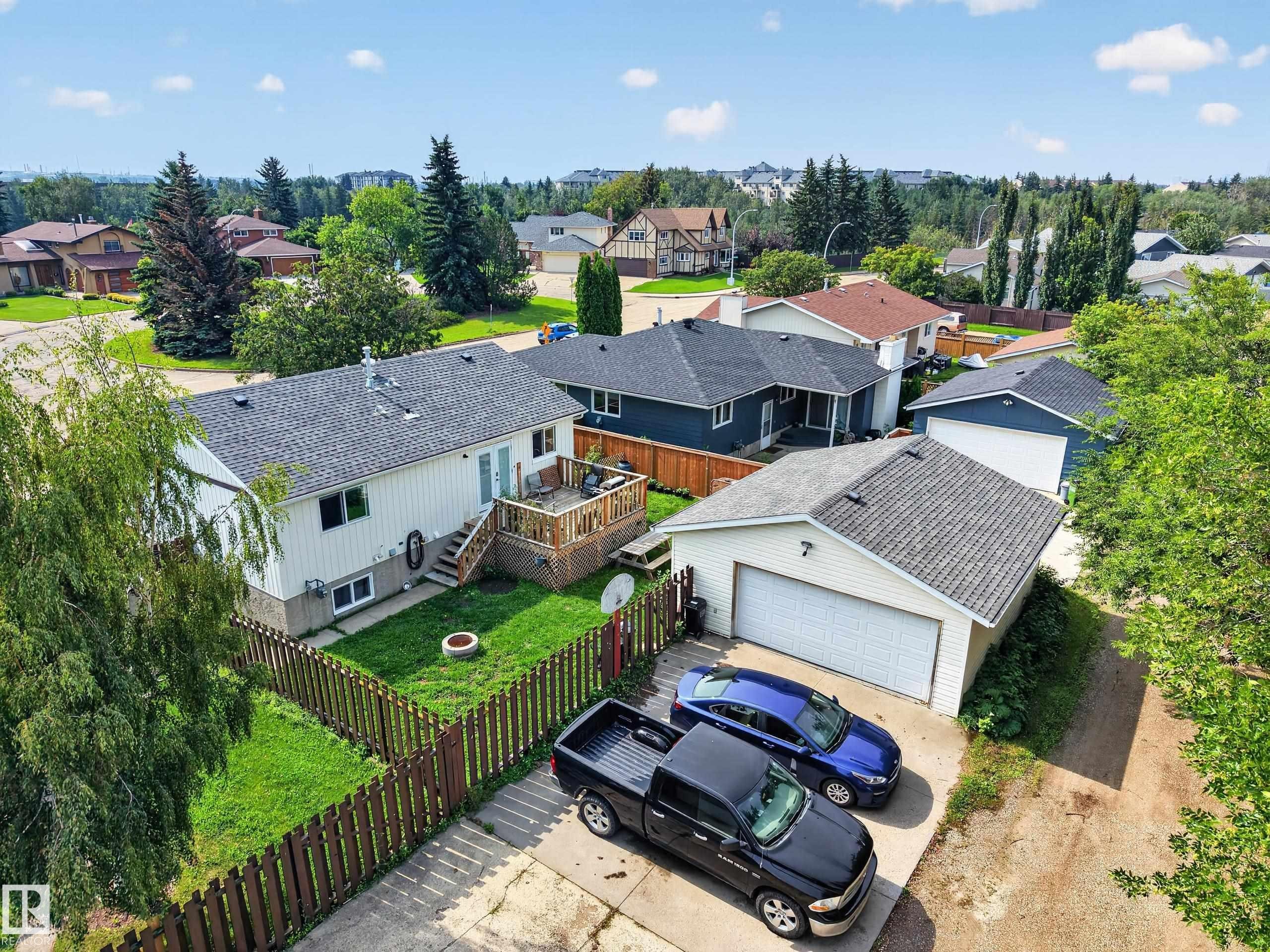 White siding exterior with a dark shingle roof - 156 Clareview Road Nw, Edmonton, AB - Outdoor With Deck Patio Veranda