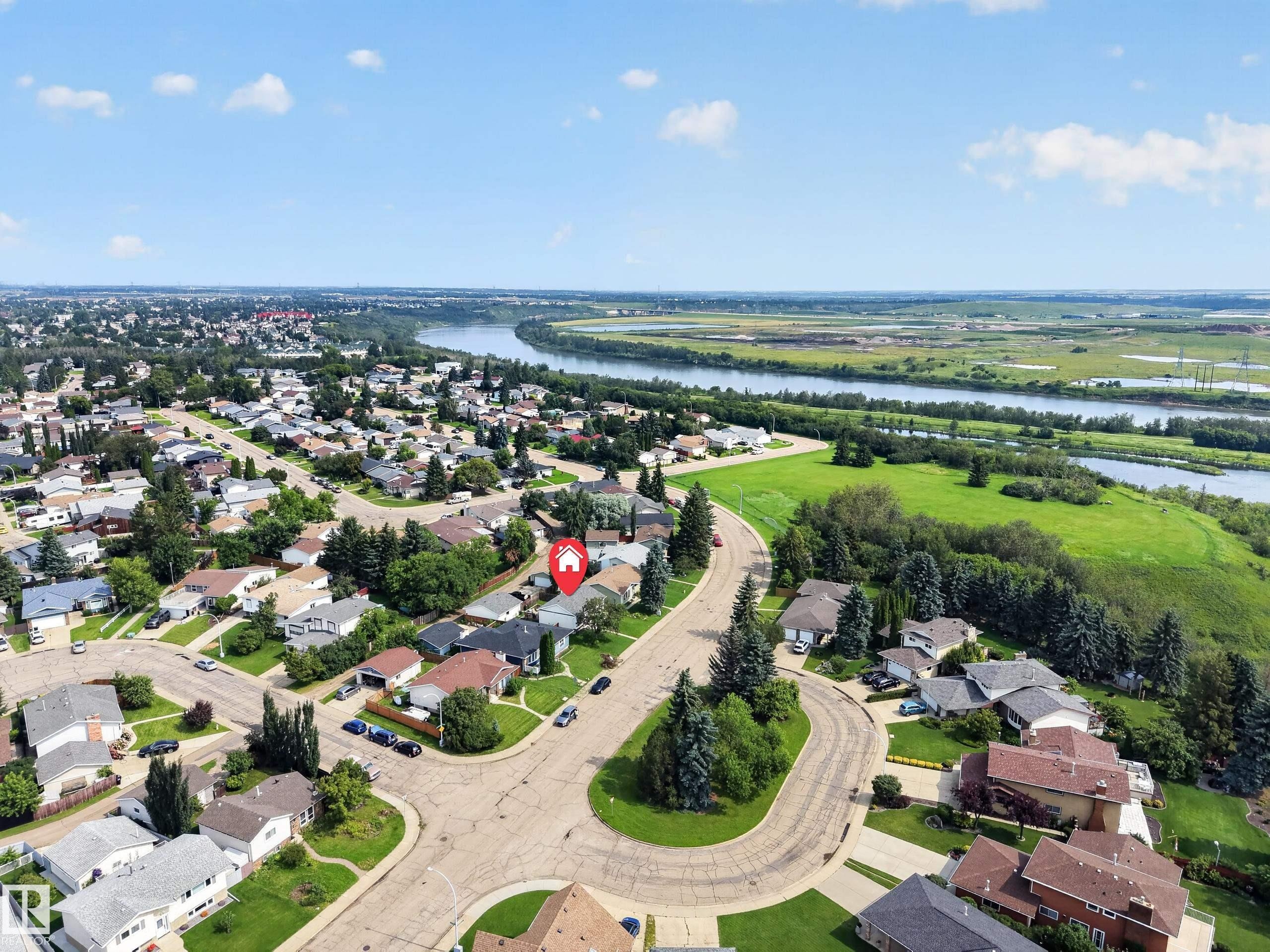 Residential neighborhood with mature trees, established properties, and a prominent river backdrop - 156 Clareview Road Nw, Edmonton, AB - Outdoor With View