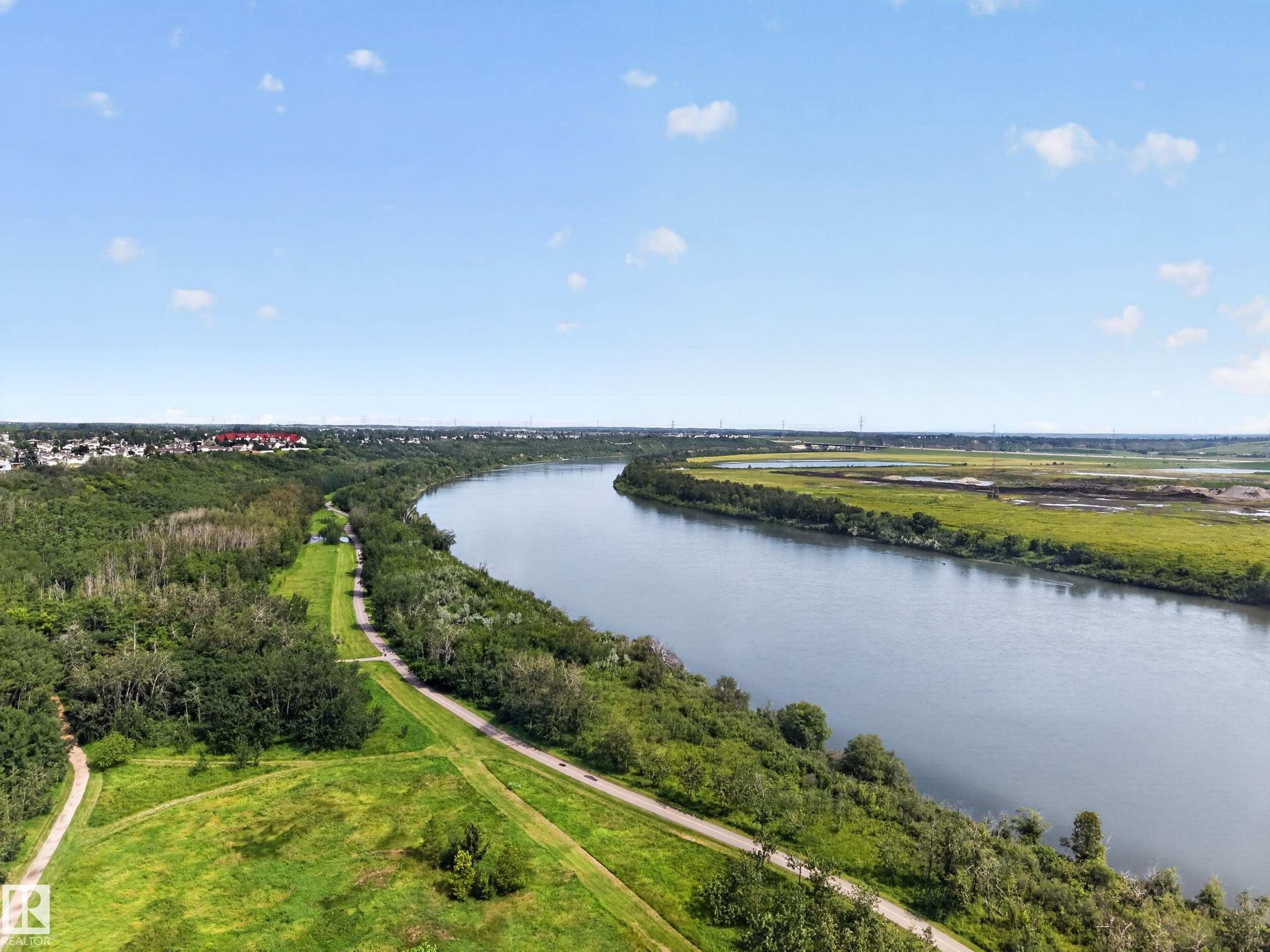 Expansive riverfront setting with surrounding green spaces and established residential areas - 156 Clareview Road Nw, Edmonton, AB - Outdoor With Body Of Water With View