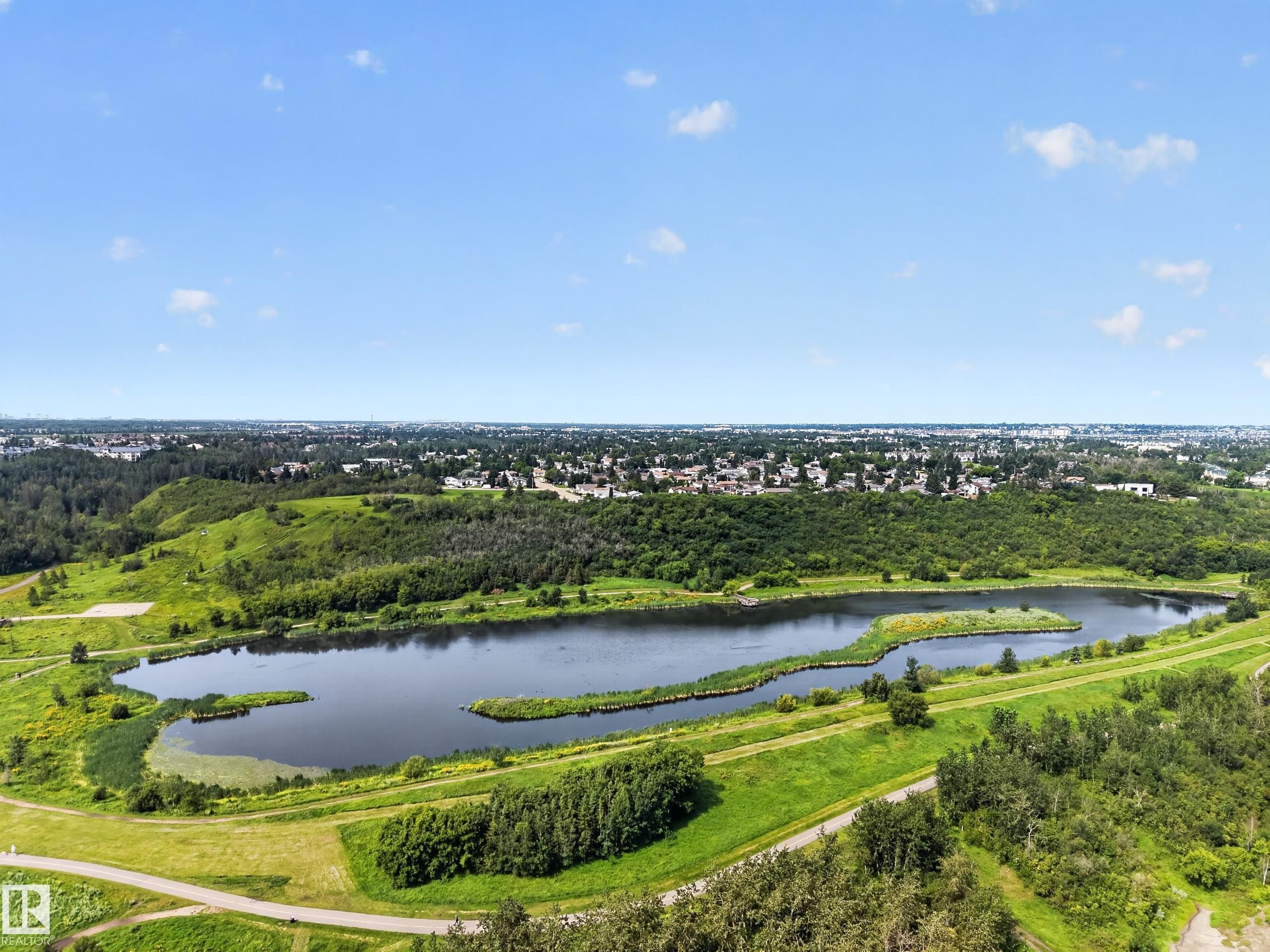 Expansive natural landscape featuring a serene lake, surrounding green spaces, and mature trees - 156 Clareview Road Nw, Edmonton, AB - Outdoor With View