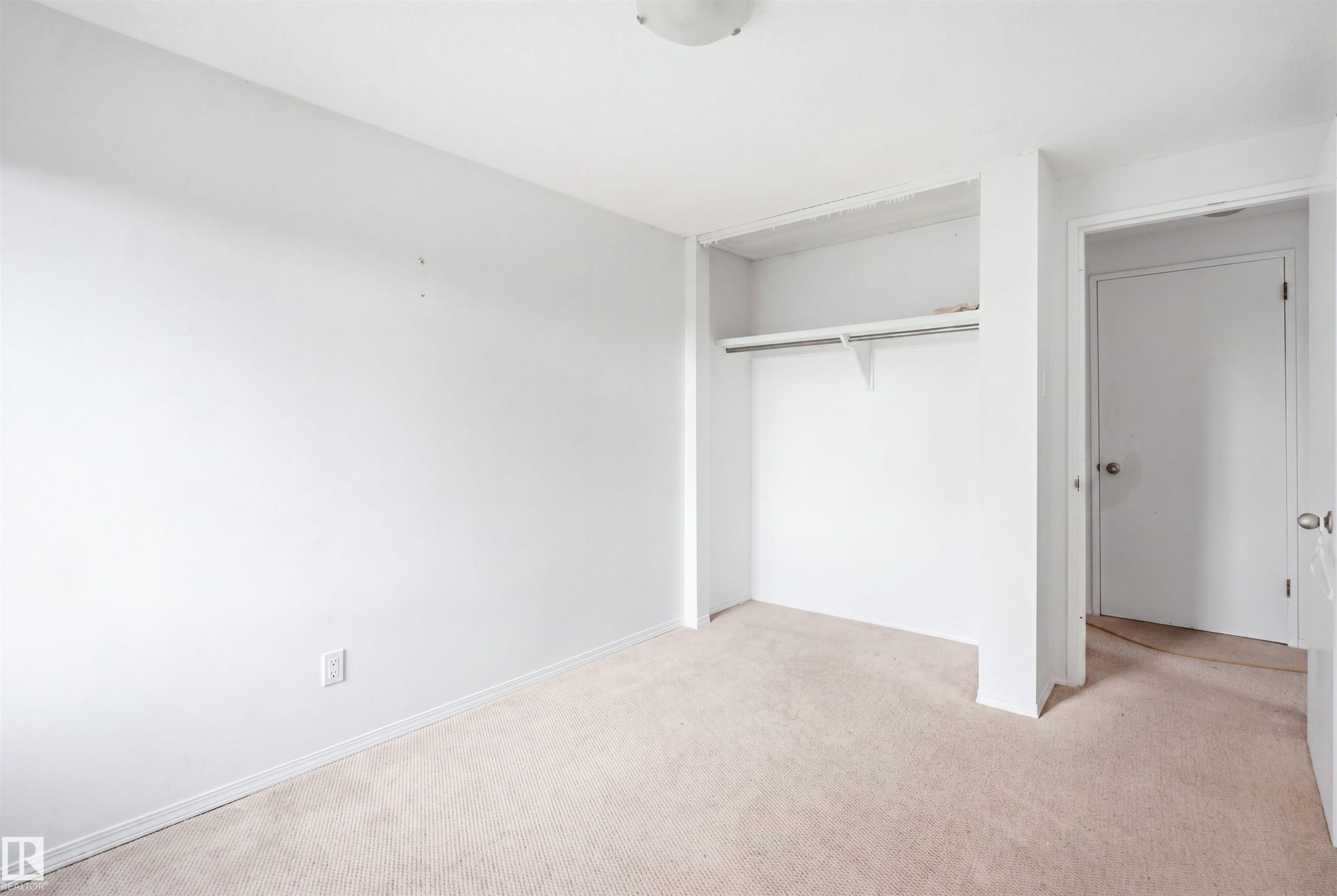 Recessed closet with a single shelf and hanging rod - 7825 159 Street Nw, Edmonton, AB - Indoor Photo Showing Other Room