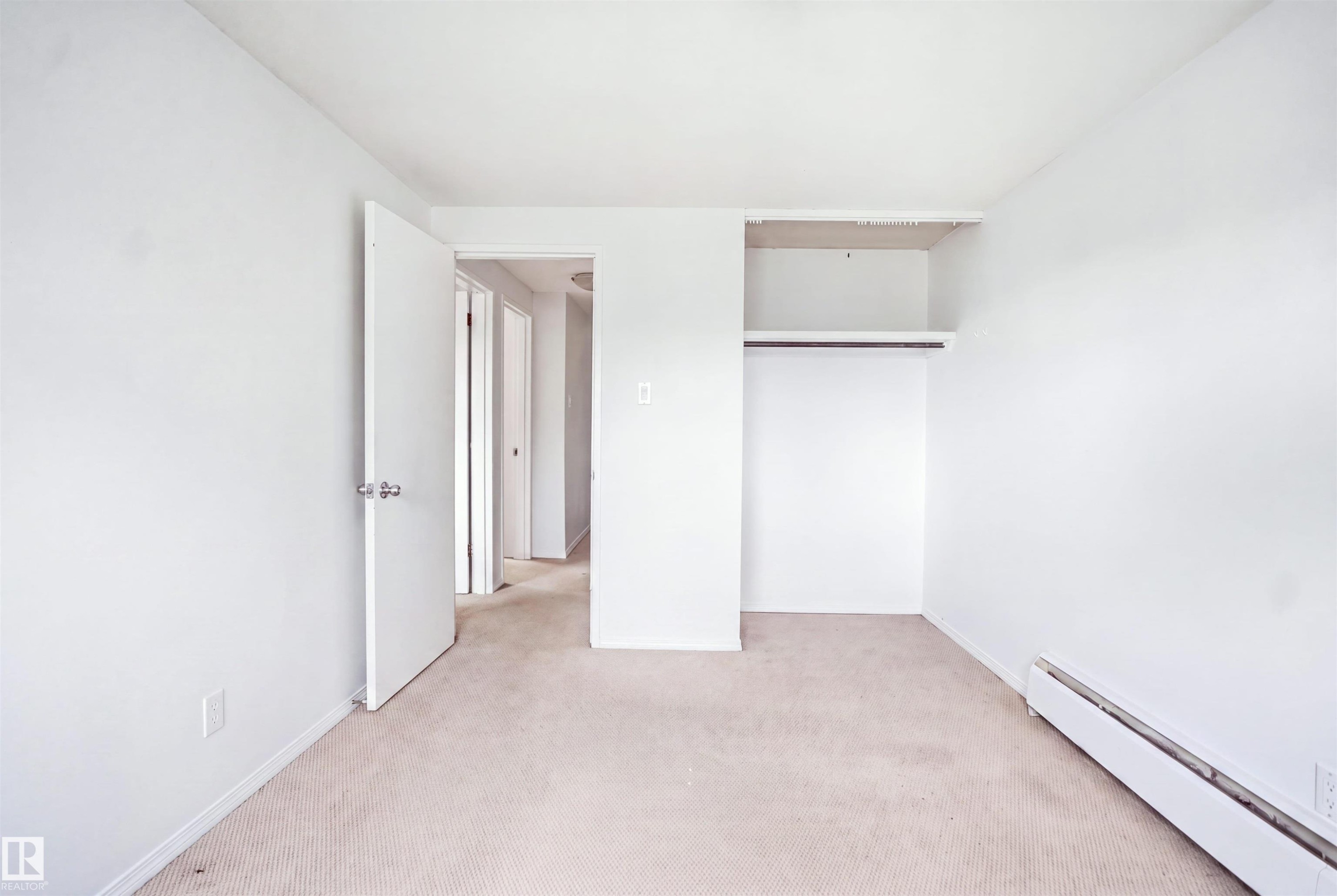 Carpeted flooring, white walls, and an open closet with shelving and hanging rod - 7825 159 Street Nw, Edmonton, AB - Indoor Photo Showing Other Room