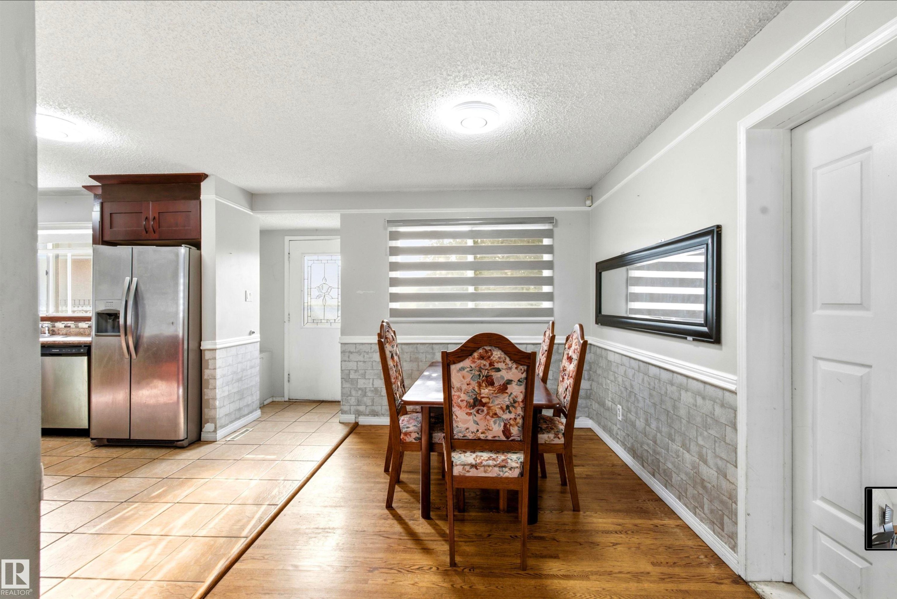 Hardwood flooring, tile flooring, stainless steel refrigerator, and recessed lighting - 13604 90A Street Nw, Edmonton, AB - Indoor Photo Showing Dining Room