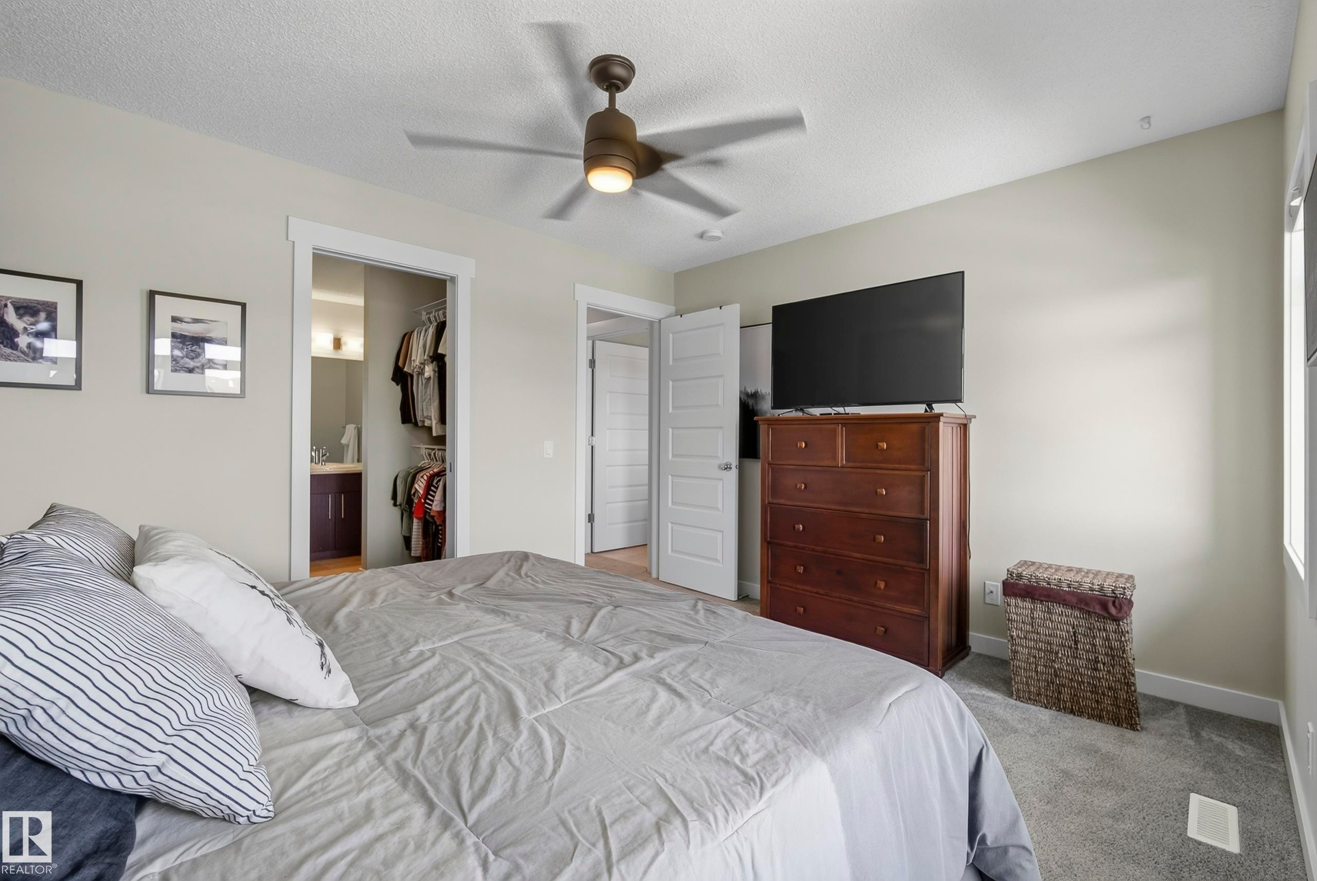 Bedroom with carpet flooring, a ceiling fan, and a built-in closet system - 45 Joyal Way, St. Albert, AB - Indoor Photo Showing Bedroom