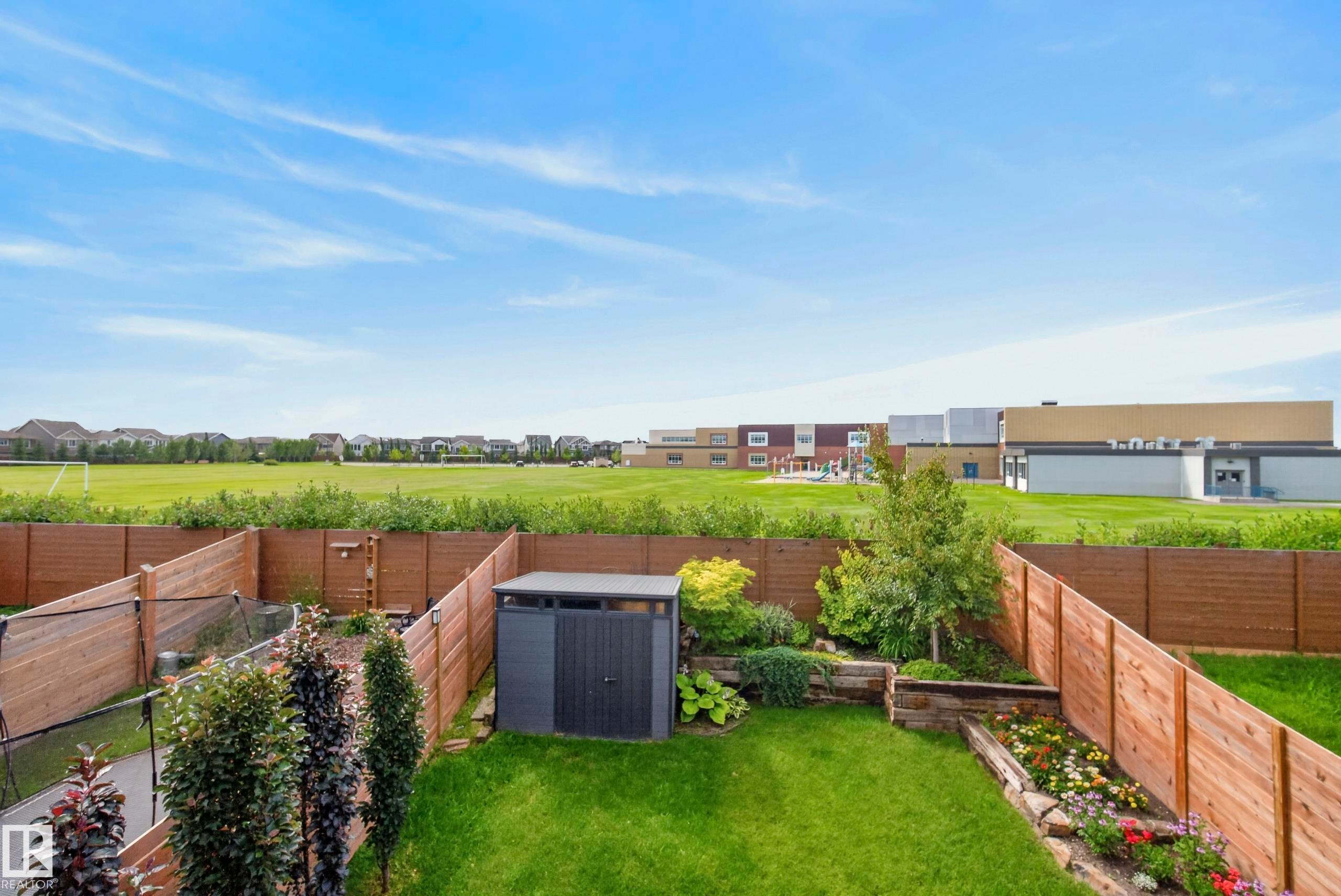 Landscaped backyard featuring a storage shed and wood fencing - 45 Joyal Way, St. Albert, AB - Outdoor
