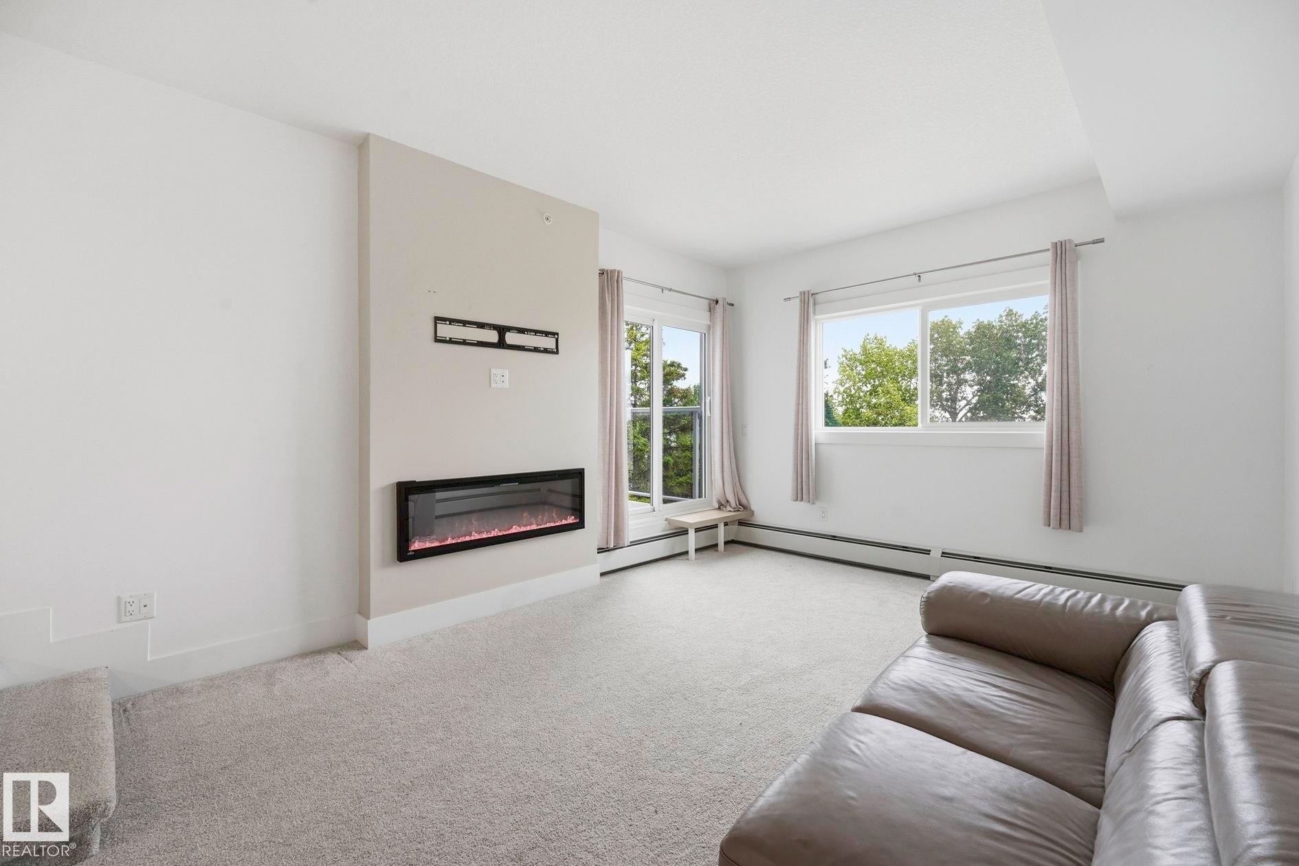 #416 9504 182 St Nw, Edmonton, AB - Indoor Photo Showing Living Room With Fireplace