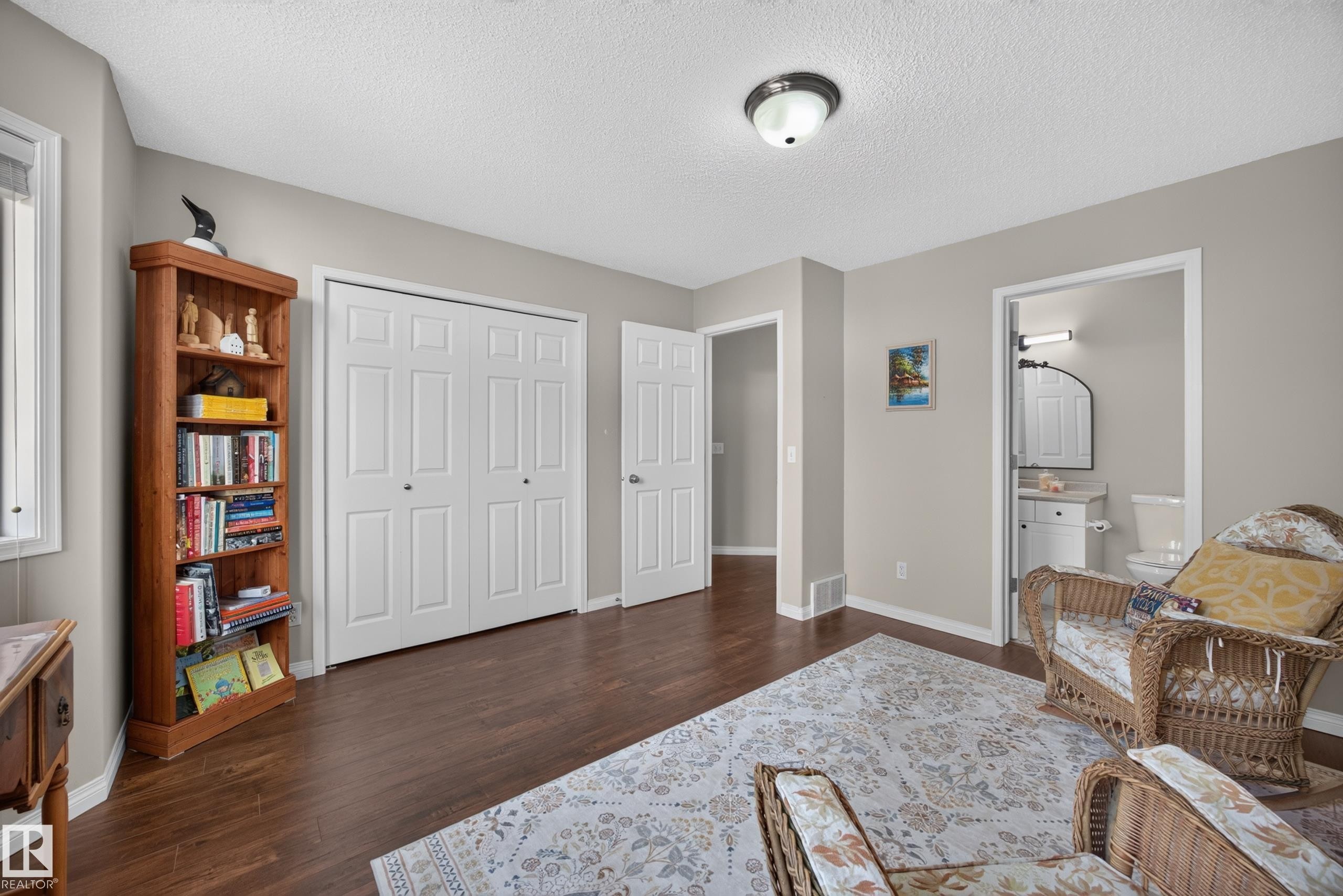 Room featuring dark wood-finish flooring, light neutral-toned walls, and white trim - #7 155 Crocus Cr, Sherwood Park, AB - Indoor