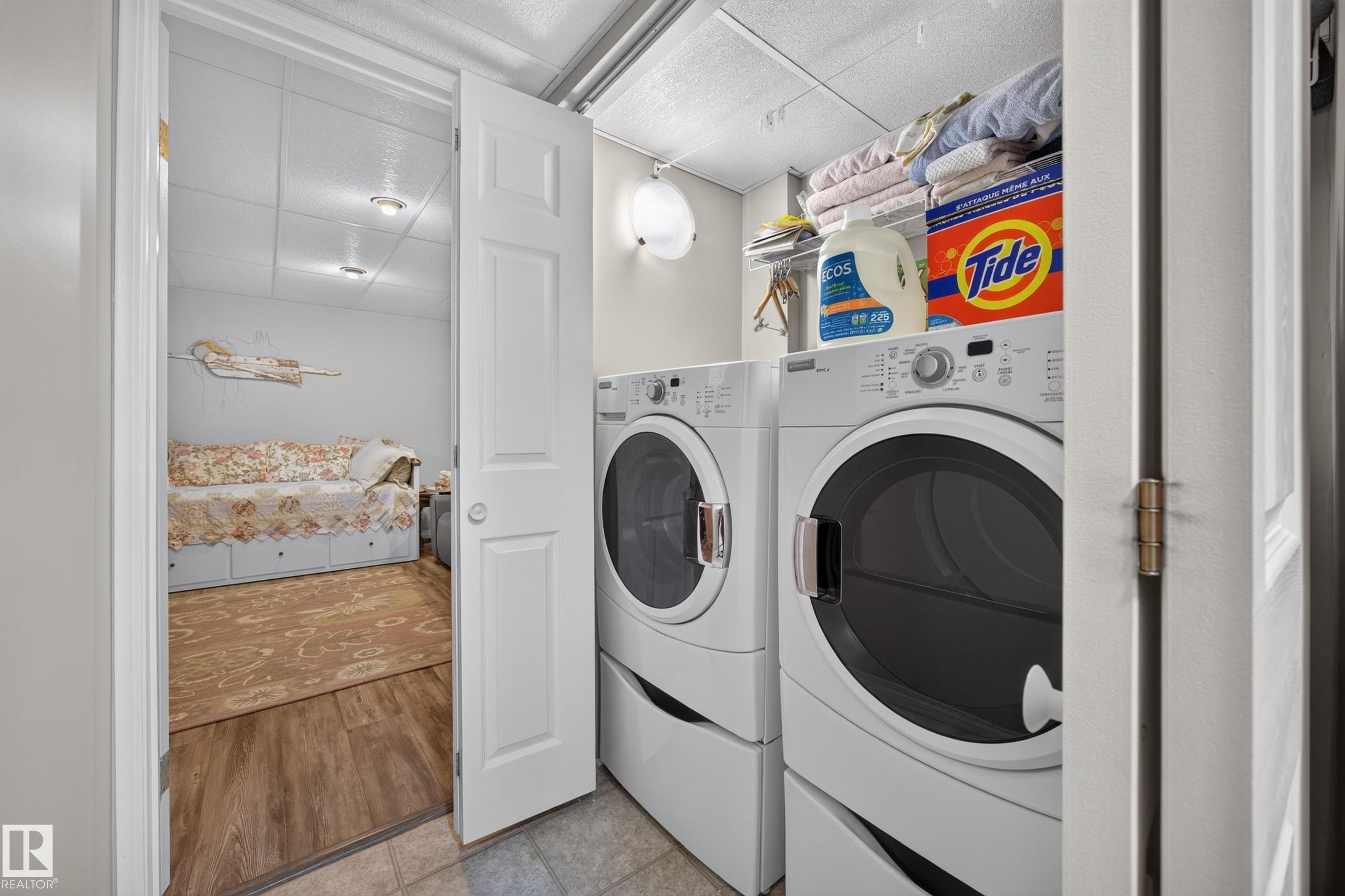 Dedicated laundry area featuring stacked washer and dryer units - #7 155 Crocus Cr, Sherwood Park, AB - Indoor Photo Showing Laundry Room