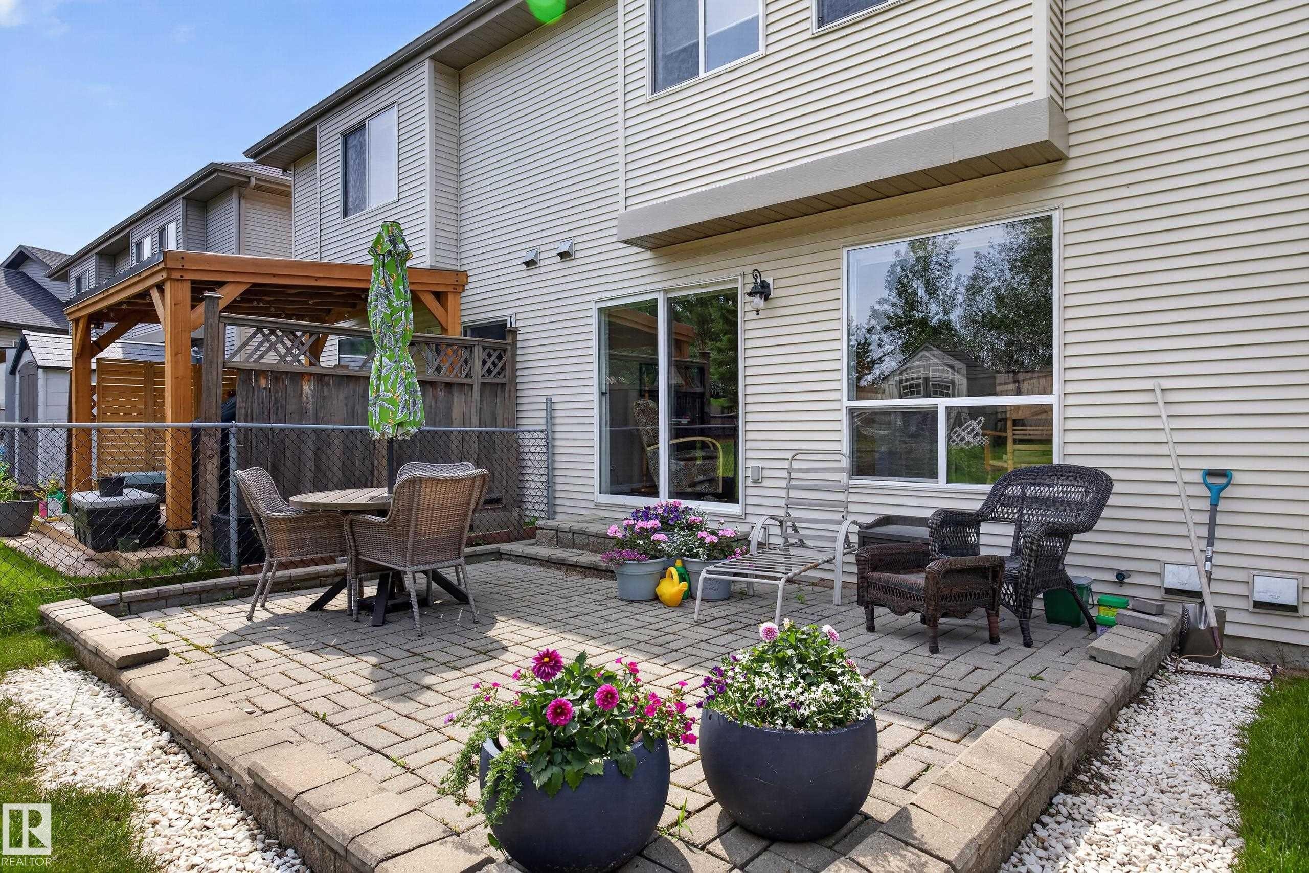 Paver patio with a low retaining wall - #7 155 Crocus Cr, Sherwood Park, AB - Outdoor With Deck Patio Veranda With Exterior