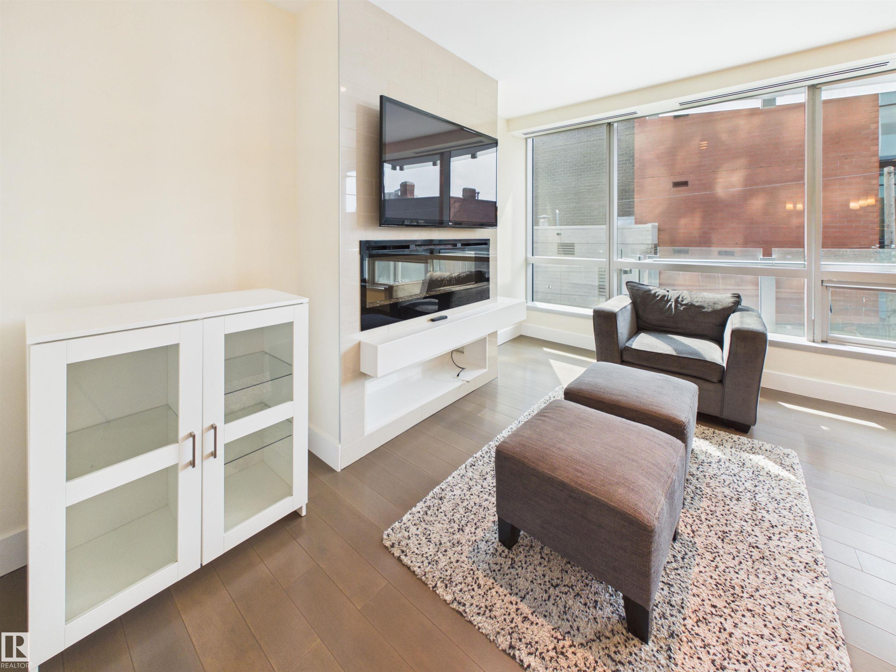#307 11969 Jasper Av Nw, Edmonton, AB - Indoor Photo Showing Living Room With Fireplace
