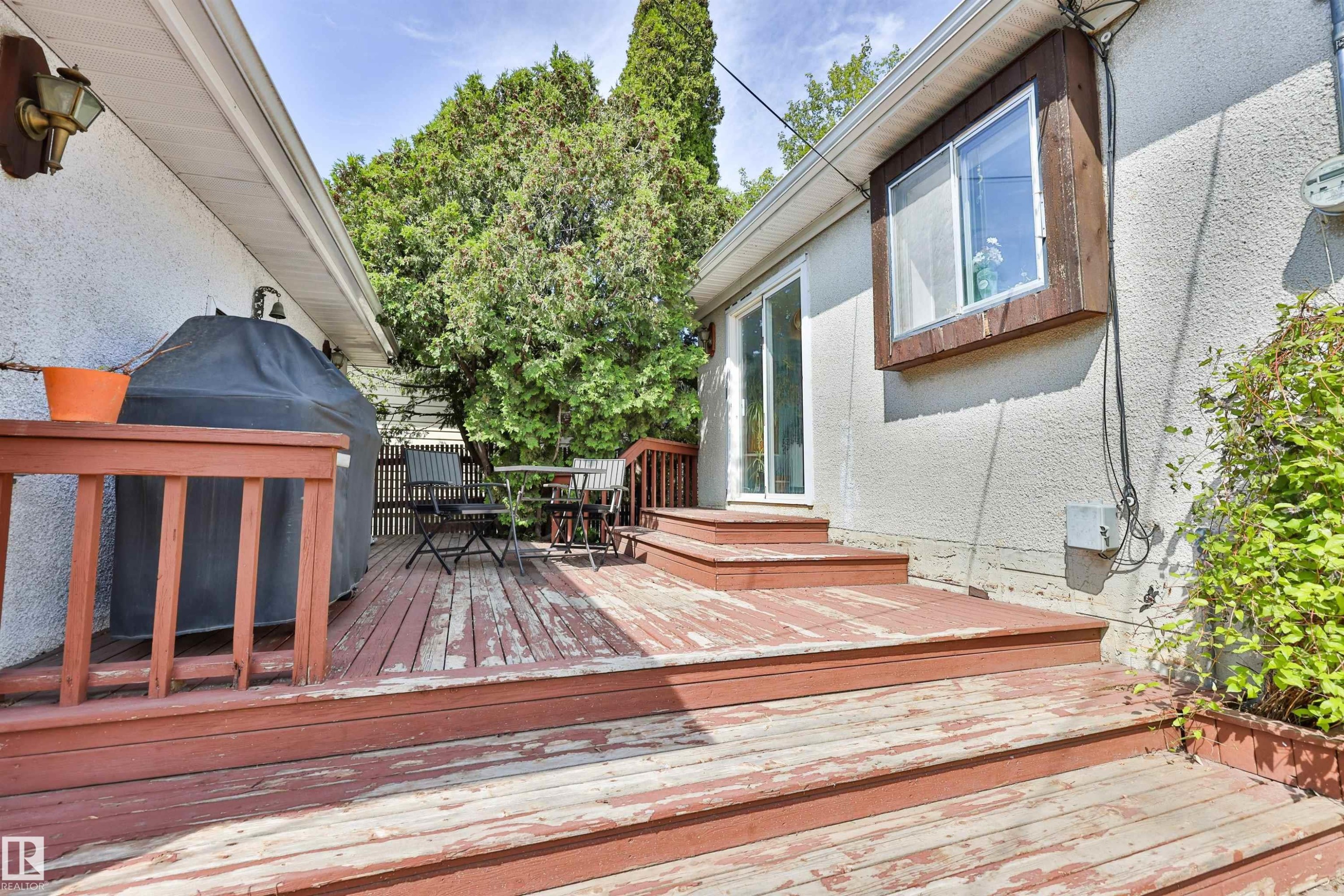 Wood deck with a built-in railing, offering direct access to the interior via a sliding glass door - 3824 111B Street Nw, Edmonton, AB - Outdoor With Deck Patio Veranda With Exterior