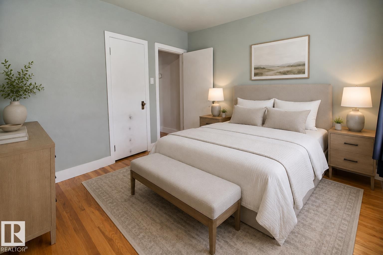 Hardwood flooring, light-toned walls, and a white interior door with dark hardware - 11336 83 Street Nw, Edmonton, AB - Indoor Photo Showing Bedroom