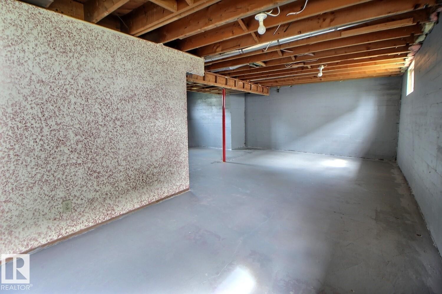 Unfinished basement space with exposed wood joists and concrete flooring - 11336 83 Street Nw, Edmonton, AB - Indoor Photo Showing Basement