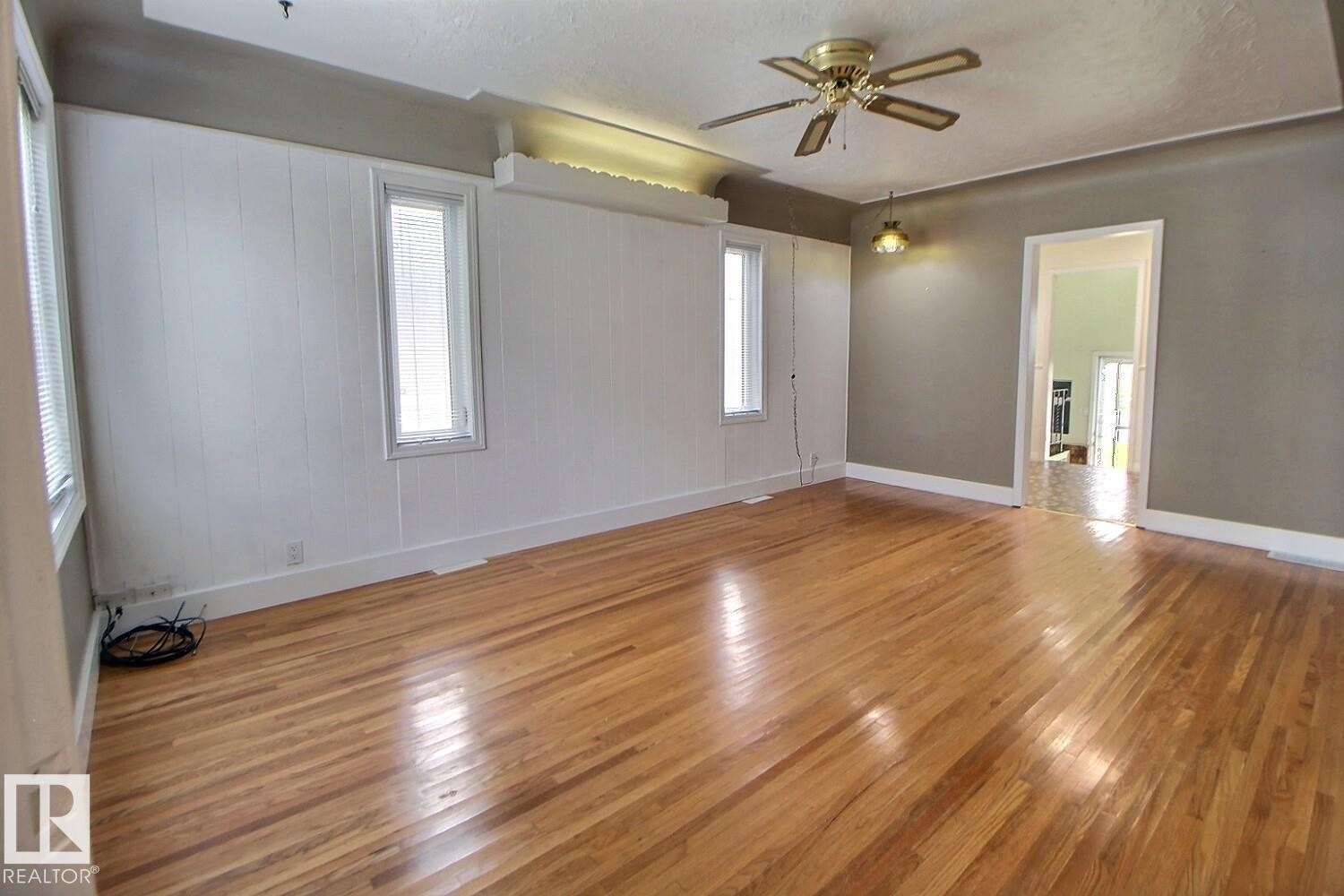 Hardwood flooring throughout, with a ceiling fan, and recessed lighting - 11336 83 Street Nw, Edmonton, AB - Indoor Photo Showing Other Room