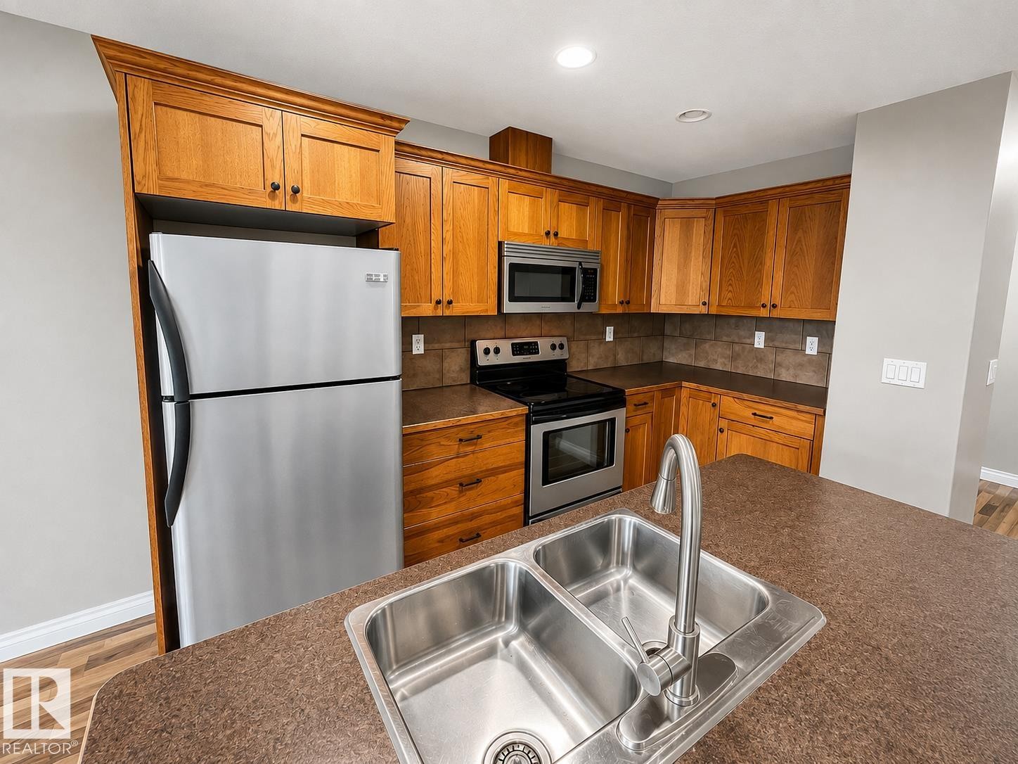 27 Deer Coulee Drive, Didsbury, AB - Indoor Photo Showing Kitchen With Stainless Steel Kitchen With Double Sink