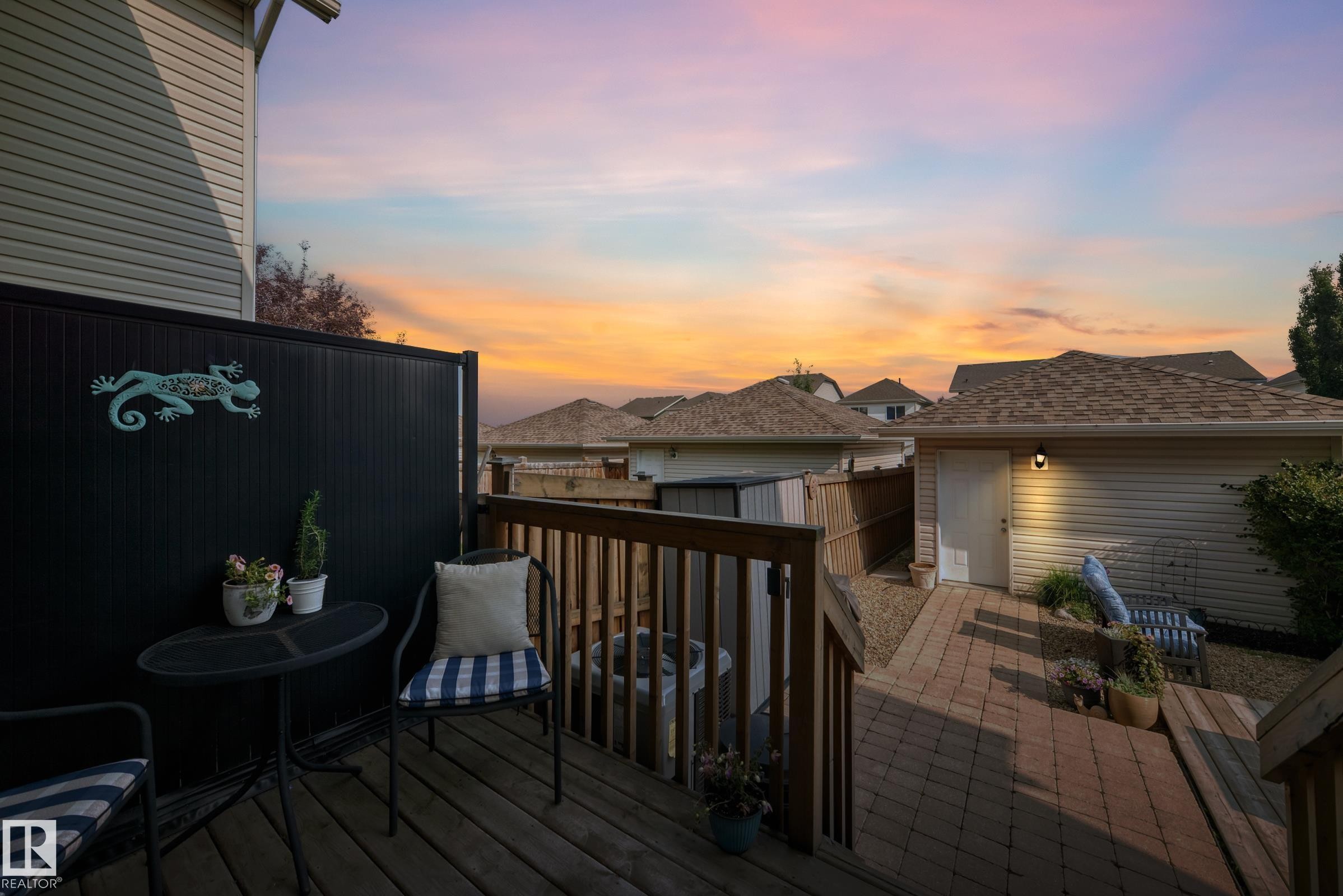 Multilevel wood deck with privacy screen, leading to a paver patio and detached garage - 466 Chappelle Drive Sw, Edmonton, AB - Outdoor With Deck Patio Veranda With Exterior